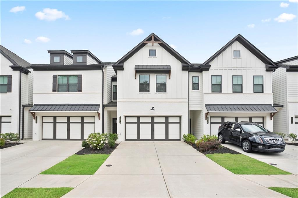 Discover modern living in this beautifully designed Gainesville townhome, offering 3 bedrooms, 2.5 bathrooms, and a spacious 2-car garage. The kitchen features soaring ceilings and sleek white cabinetry, creating a bright and airy feel throughout. An open-concept layout flows into the inviting family room, highlighted by a striking electric fireplace—perfect for relaxed evenings at home. Upstairs, the impressive primary bathroom offers a spa-like atmosphere with upscale finishes and thoughtful design. The master suite is a peaceful retreat with ample space and natural light. Two additional bedrooms share a well-appointed full bath, ideal for family or guests. Washer, dryer, and refrigerator are included, adding extra convenience to this move-in ready home. This property stands out for its pristine condition, offering the comfort of a well-kept residence without the wait of new construction. Filled with charm, it’s the perfect blend of style and practicality.