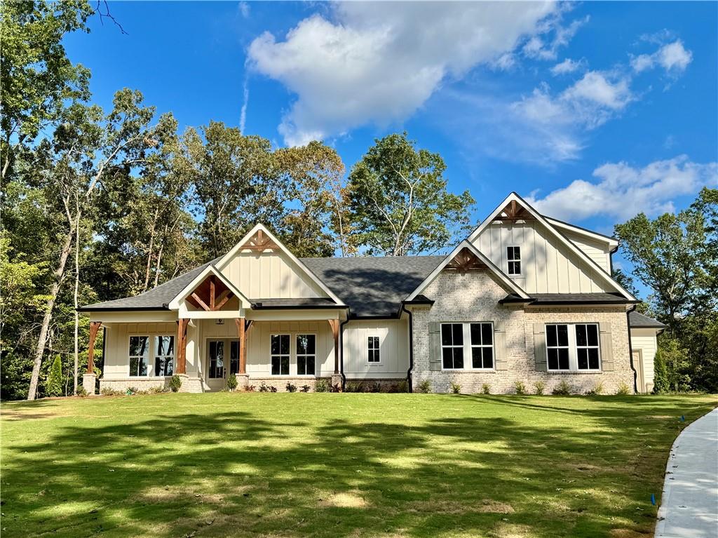 Brand New Custom Ranch Estate Home - nestled on over 3.3 private acres in an exclusive gated community. A long, winding driveway leads to this stunning home perched on a gentle hilltop, offering a perfect blend of luxury, functionality, and serene countryside living.
Designed with both beauty and comfort in mind, this spacious home features 5 bedrooms and 4.5 baths, including four bedrooms on the main level and a private upstairs suite with its own full bath — ideal for guests or multigenerational living. Step inside to find durable and elegant LVP flooring throughout, designer tile selections in each bath, and breathtaking Taj Mahal quartzite countertops in the chef’s kitchen. The kitchen is a showstopper, complete with a massive walk-in pantry that includes custom cabinetry and a built-in beverage fridge — perfect for entertaining or everyday ease.
The open-concept living area showcases vaulted ceilings and a brick fireplace, setting the stage for cozy gatherings. Rich architectural details abound, including tongue-and-groove wood ceilings on both the front and rear porches, accented by cedar columns and decorative corbels, plus refined custom trim work throughout the home — from the mud bench to the built-ins. The expansive laundry room, thoughtfully located off the master closet, offers exceptional storage and custom cabinetry, making it as beautiful as it is functional.
Outside, the home’s grey flagstone porches create inviting outdoor living spaces where you can enjoy the peace and privacy of your surroundings. The oversized three-car garage provides ample space for large vehicles, recreational toys, or even a workshop.
123 Stillwater Lane is more than just a home — it’s a private retreat designed for those who appreciate craftsmanship, space, and quiet luxury. Don’t miss your opportunity to own this one-of-a-kind property before construction is complete.