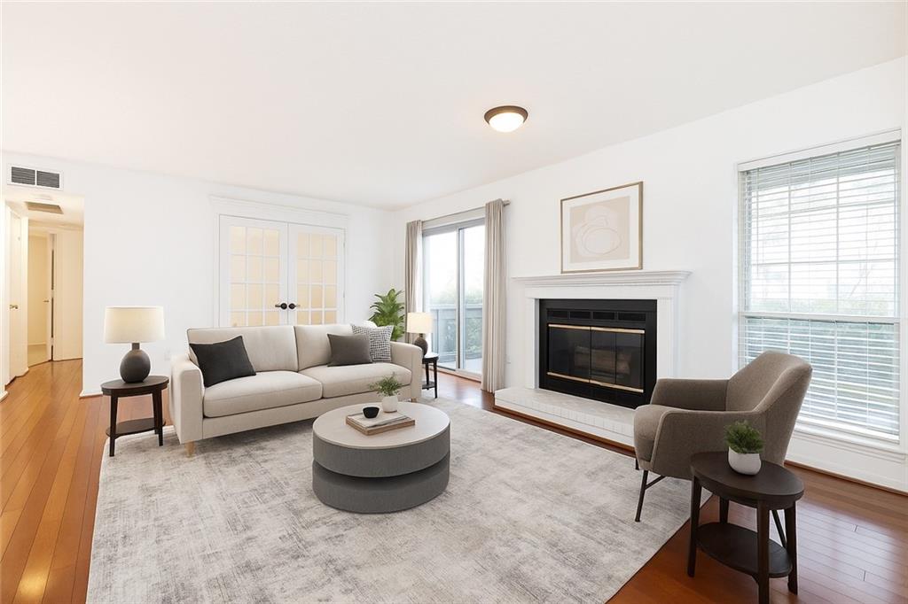 Beautifully updated, step-free condo in prime Buckhead location. Freshly painted with gleaming hardwoods, this 2/1 offers ample space and storage throughout. The kitchen is large and features an eat-in area, white cabinets, granite counters, & SS appliances. The separate dining area is open to the cozy, fireside living area. This unit has great outdoor space, with a large covered patio off the living area. The bathroom features an updated vanity w/ double sinks and a tub/shower combo. The primary suite is spacious and features 2 closet spaces, including a large walk-in. Conveniently located close to major interstates, shopping, dining, and more, but tucked away in a quiet, gated, wooded community.