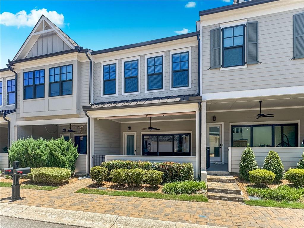 Available Now! Like-New Luxury Townhome in Sought After Village at Towne Lake! Beautiful finishes throughout. Inviting, open-concept floorplan. The large slider doors in the family room open to a great outdoor space with a covered porch for entertaining. Enjoy cooking and relaxing w/ an open chef-inspired kitchen & living area w/ 10+ ft ceilings. This home has modern touches like stone countertops w/ plenty of cabinets and walk-in pantry as well as upgraded lighting . Upstairs you will notice 10ft ceilings and an open rail staircase. The owner’s suite showcases a modern light double vanity w/ upgraded countertop, an oversized shower & expansive walk-in closet. Also upstairs, 2 guest BRs with walk-in closets, 2nd full bath with tiled walls and a laundry room. As a bonus the community is gated, beautifully maintained and offers a range of amenities such as: a pool, pickleball court, bocce ball, fire pit, a dog park and more. Resident Benefit Package included. Check out our 5-Star Reviews on Google. Rent quoted reflects discount for on time payment, ask for details.