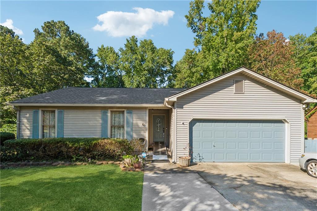Welcome to this charming 3-bedroom, 2-bath single-level home in Lilburn! Featuring a spacious open floorplan, beautiful hardwood flooring, and a cozy masonry fireplace, this home is perfect for relaxing or entertaining. Enjoy cooking in the updated kitchen with granite countertops and stainless-steel appliances, plus a dining area with views of the private fenced backyard. Step out onto the rear deck or screened porch overlooking mature trees, ideal for outdoor living. Quiet neighborhood with no HOA, award-winning Brookwood schools nearby, and easy access to shopping, dining, parks, and commuter routes. Don’t miss your opportunity!