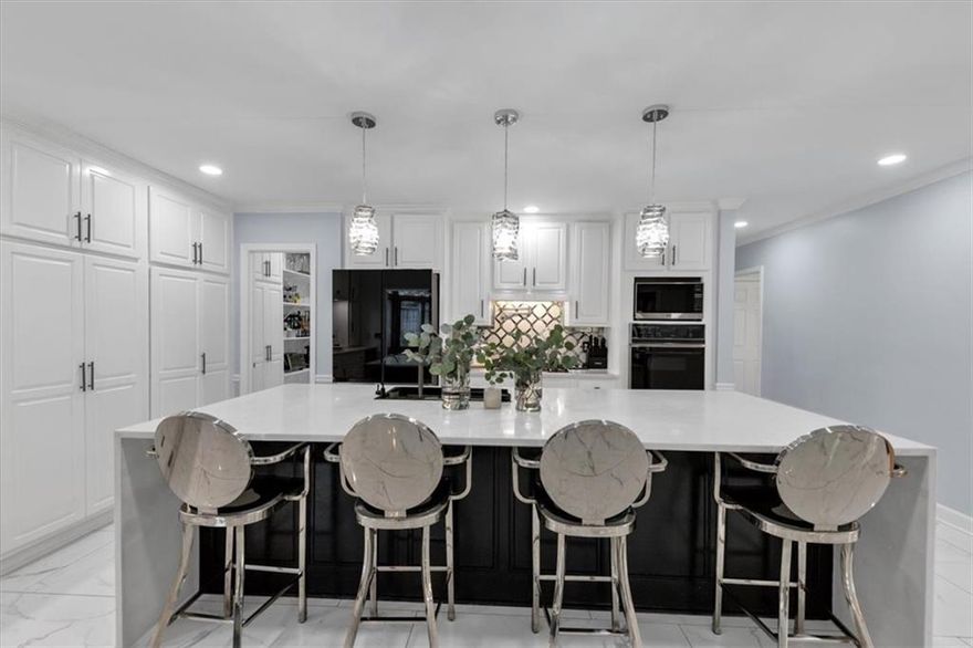 This beautifully renovated brick home in East Cobb’s prestigious Woodhaven subdivision combines timeless design with modern sophistication. Located in one of Georgia’s most sought-after school districts, Sope Creek Elementary, Dickerson Middle, and Walton High, this property offers luxury living in an unbeatable location. Step inside to find custom hardwood stairs and banister, elegant lighting, and new designer paint throughout. The expansive great room features rich hardwood floors with matching in-floor ventilation and an open layout created by the removal of the engineered separation wall. The primary suite on the main level is a serene retreat with dual Elfa-customized closets and a marble and hardwood spa bathroom featuring a six-function steam shower, aromatic air-jet soaking tub, high-efficiency toilet, and private stairway to a flexible office or closet space. The chef’s kitchen showcases marble flooring, double quartz countertops with built-in outlets, marble backsplash, prep sink, multi-function filtered water system, built-in pot filler, and a butler’s pantry with wine rack. A newly added half bath with pocket door separation adds convenience and style. Enjoy the sunroom with natural slate flooring, overlooking a fully resurfaced pool with new electrical, Bluetooth lighting, upgraded filtration system, resurfaced deck, and new paver stones, perfect for year-round entertaining. Upstairs, two spacious bedrooms feature updated lighting, ceiling fans, and fresh paint, each with newly designed bathrooms offering dual sinks, designer tile, and dual adjustable shower heads. One bedroom includes a mirrored secret door to the primary flex space, while the other enjoys a private water closet. The finished basement provides multiple living spaces and a newly renovated full bath with a designer marbled shower and tall ceilings, ideal for guests or recreation. Every inch of this home has been meticulously upgraded, from electrical and lighting to flooring, paint, and custom storage, creating a move-in ready masterpiece that blends luxury, comfort, and craftsmanship. Conveniently located near East Cobb’s premier shopping, dining, and parks, this home offers the perfect balance of elegance and everyday ease.