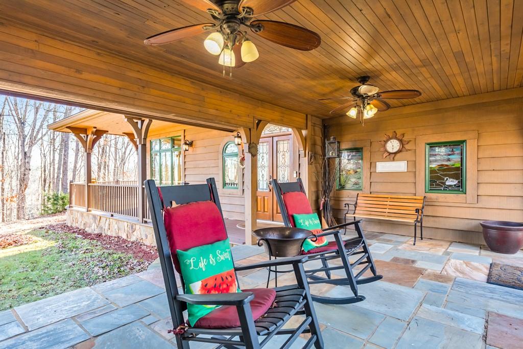 Welcome to your dream retreat in Cartersville! Nestled on 20 private, partially wooded acres, this serene property includes a stunning 4 bed / 5 bath cabin-style home with exceptional outdoor living spaces. This property offers an idyllic escape or the perfect opportunity for short-term rentals. The outdoor living areas are thoughtfully designed to showcase the breathtaking natural surroundings. Relax on the expansive wraparound deck, enjoy quiet moments on the screened-in porch, or savor the charm of the covered breezeway connecting the garage to the main house. Thoughtfully positioned, the front of the home faces west for stunning sunset views, while the back offers a tranquil spot to watch the sunrise. Step inside to discover maple hardwood floors and a sunlit main level ideal for gatherings. High-quality Anderson windows throughout. The gourmet kitchen is a chef's dream, featuring a large island, stainless steel appliances, a gas cooktop, a warming drawer, an ice maker, trash compactor, and a cabinet-front refrigerator. Adjacent to the kitchen, the dining area is perfect for hosting family meals and creating lasting memories. The cozy living room invites you to relax by the fireplace while enjoying panoramic wooded views, with direct access to the furnished screened-in porch. The deck off the grand piano room provides another perfect spot to soak in the evening sunsets. A furnished versatile main-level bedroom, perfect for an office, is complemented by a full bathroom and a laundry closet. Upstairs, the primary suite is a true retreat, featuring soaring ceilings, a fireplace, and a spacious walk-in closet. The en suite bath includes a double vanity, a jetted tub, and a shower-sauna combo. Another upstairs bedroom impresses with vaulted cedar ceilings, a large walk-in cedar closet, a second closet, and a private en suite. A third bedroom also offers its own bathroom with dual vanities. All upper-level bathrooms feature beautiful new tile flooring, adding a fresh and modern touch. The fully finished basement, with private exterior access, is ideal for rental income or guests, offering a kitchenette, full bathroom, rec room, media room with built-in bookshelves, and durable LVP flooring. The separate garage features a spacious bonus room above, providing endless possibilities for a home office, gym, or additional living space. Completing this extraordinary property is a picturesque pond and pasture, offering a tranquil setting to unwind and connect with nature. This home seamlessly blends luxurious living with natural beauty, offering endless possibilities for relaxation or investment. Don’t miss your chance to make this extraordinary retreat your own!