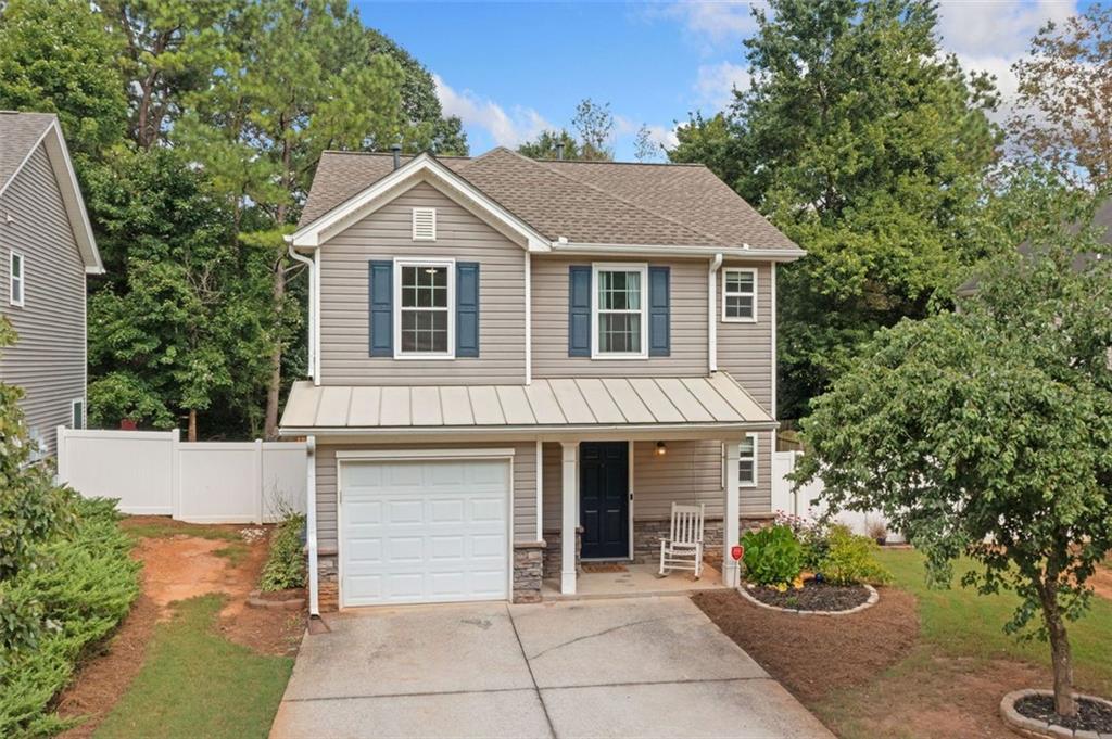 This beautifully maintained 2-bedroom, 2 1/2-bath home features a spacious and flexible floor plan, including a versatile loft ideal for an office, media room or an extra bedroom. Enjoy outdoor relaxation on the covered patio and the convenience of a one-car garage. Recent upgrades include a newer roof, hot water heater, remodeled upstairs bathrooms, New carpet upstairs, new appliances and several new windows throughout. Situated in a highly desirable, up-and-coming area with an array of shopping, dining, and local amenities, this home blends comfort, style, and convenience all in "Highly Desirable" Cherokee County Schools district. Don’t miss your chance to own in this vibrant neighborhood. HOA Community quarterly fee of $79.40 does include mowing front yard. Plus a $400.00 a year fee.