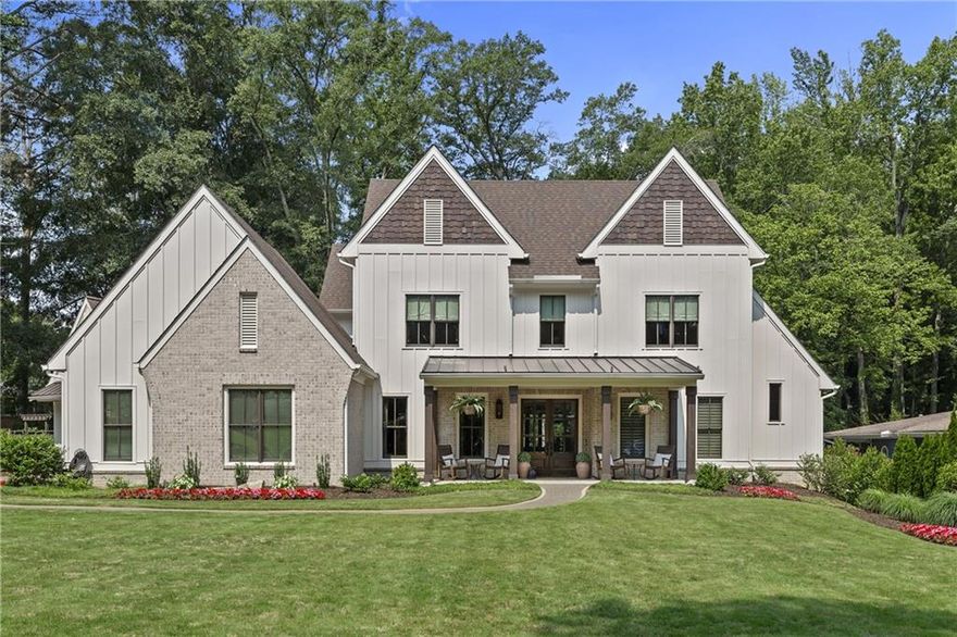Ideally positioned less than a mile from the vibrant shops and dining of Downtown Alpharetta, this custom-built home seamlessly blends timeless elegance with today’s most desired conveniences. From the moment you arrive, this residence captivates with its brick herringbone front porch, accented by a stained tongue-and-groove ceiling - a warm invitation into the exceptional craftsmanship that defines the interior.
Enter through the grand entryway and experience an inviting ambiance defined by soaring 10-foot ceilings, wide-plank hardwood floors, and meticulous architectural detailing. A sophisticated office with custom built-ins provides an inspiring workspace, while the exquisite dining room, illuminated by a statement Currey & Co chandelier, is perfect for intimate gatherings. The heart of the home unfolds in the expansive family room, where bespoke built-ins frame a gas fireplace, seamlessly flowing into a sunlit breakfast nook and a chef's dream kitchen. Designed for beauty and function, the kitchen features top-of-the-line Sub-Zero and Wolf appliances, custom shaker cabinetry, a striking wood hood, and an oversized island crowned with quartz countertops and a secondary prep sink. A hidden scullery offers additional storage and workspace, while an artistic wine bar featuring a specialty ice maker, wine refrigerator, and bottle storage enhances the home's entertaining capabilities. Blurring the lines between indoor and outdoor living, double sliding glass doors lead to an exceptional screened porch with a wood-burning fireplace and retractable screens with all-weather covers. Beyond, a picturesque backyard oasis awaits, featuring a stone patio with a built-in grill and fire pit - an idyllic setting for al fresco gatherings. Modern conveniences abound on the main level, including a thoughtfully designed mudroom drop zone, an oversized laundry room with extensive cabinetry and quartz countertops, and a flexible bonus nook, ideal as a reading retreat, Peloton space, or sunny sanctuary for pets. The primary suite on the main level is a true sanctuary, showcasing cathedral vaulted ceilings with exposed wood beams and a spa-inspired bath with dual quartz vanities, a spacious walk-in shower with a frameless glass enclosure, designer tile, and a custom walk-in closet with bespoke built-ins. Ascend to the upper level, where a fabulous loft-style bonus room with a beverage bar and refrigerator serves as a refined retreat. Three private bedroom suites, each adorned with luxurious quartz countertops, designer tile, and generous walk-in closets provide serene havens for family and guests alike. For added convenience, this home features a spacious three-car garage, including an oversized bay fully floored for extensive storage. A built-in motorized lift allows effortless transport of boxes and seasonal items to the upper level - all with the push of a button!  
A rare offering in one of Alpharetta’s most sought-after locations, this refined home now presents even greater value ~ a compelling opportunity to own extraordinary quality & design in the heart of it all!
