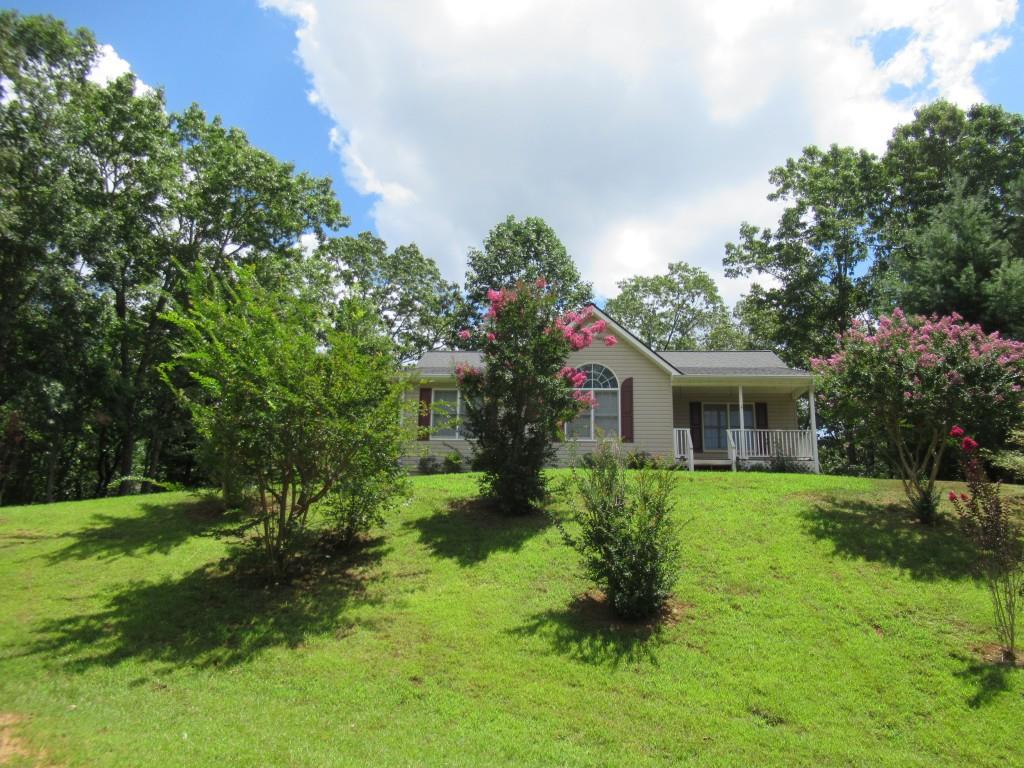 Ranch home with unfinished basement on over 1 acre in Dahlonega close to everything, yet private and peaceful. 3 bedroom and 2 full bath. Open concept main living floor plan. Kitchen with stained cabinets and open view into family room. Primary bedroom and 2 additional bedrooms are on main level. The basement is ready for your unique design & needs. No rental restrictions. Come see today.