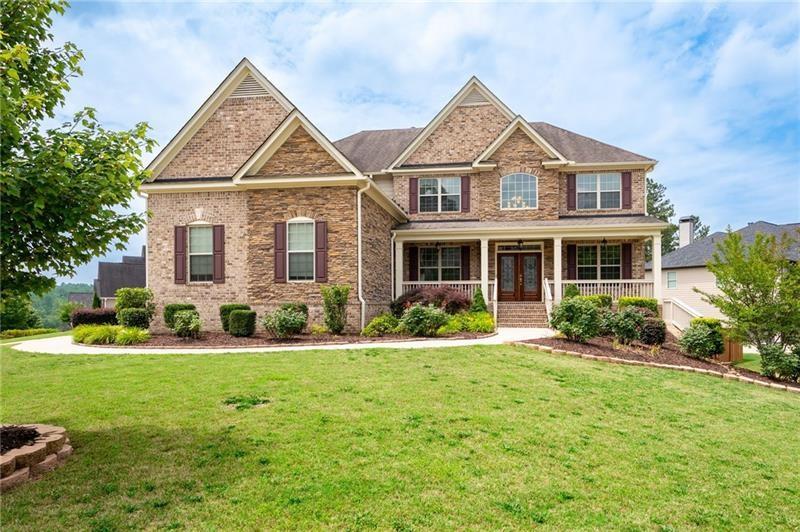 Schedule an appointment to view this gorgeous executive home that boasts 5 bedrooms and an unfinished basement on a corner lot! Renovations include new carpet throughout, new interior paint, freshly painted kitchen cabinets, newly installed built-ins in the great room, refinished hardwoods, electric blinds, tinted family room windows, tinted back door, newly stained deck, fence and a firepit sitting area. The two-story foyer and gleaming, refinished hard woods will great your guests. The chef’s kitchen is appointed with freshly painted cabinets, new pendants, stainless steel appliances to include a new refrigerator and dishwasher, granite countertops, tile backsplash, and an oversized island with seating. The kitchen opens to the sunny side eat in area with a new light fixture and the keeping room that features a vaulted ceiling, wood beams, and a brick fireplace and to the sunny eat in area. The open floor plan continues with the great room that boast, new hardwoods, a beautiful wall of windows, brick fireplace, and new built ins. The dining room features a new light fixture, trey ceiling, and wainscoting and is ready to host your dinner parties. The formal living room is perfect as a home office. Your guest will enjoy their time in their private ensuite that is appointed with new paint and new hardwoods. The second floor features the primary suite with a sitting area, trey ceiling, French doors, an oversized closet, granite counters, dual vanities, jetted tub, walk in shower, and a frosted window. There is another ensuite with a tiled shower and granite countertop. There are two additional bedrooms that share a Jack-n-Jill bathroom with a tiled shower and granite counters. Relax on your covered front porch and enjoy the sunset. The deck overlooks the private, level backyard. There is plenty of room for a pool or playset. You will enjoy your evenings by the firepit. There is a double gate on one side of the fence and single gate on other side. The basement is ready for your design and special touch. The three car garages are side entry and have extra height doors. The neighborhood is a conservation area with ample greenspace, featuring a fishing lake with dock, walking trails, pocket parks, Junior Olympic pool, kiddie pool with 4 mushroom waterfalls, clubhouse, playground, 6 lit tennis courts, basketball court, pickleball complex, and a vibrant social community. Enjoy the closeness to the North Georgia Mountains, Lake Lanier, and the North Georgia Premium Outlet Mall, adding to the unbeatable lifestyle this home offers.