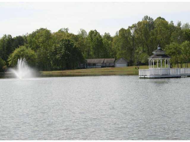Comes with 3 homes and a cabin all on the lake...36.45 acres Has gated entrance waterfall on a 7 acre lake, gazebo,dock, fountain all on lake. Close to Hamilton Mill and the new Walmart. Would be perfect for up scale neighborhood.