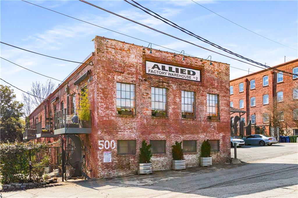 Discover this top-tier loft conversion, perfectly blending historic charm with modern luxury. Designed for both work and play, this expansive space is ideal for entertaining with its soaring ceilings, exposed brick, and period details.
Located in a prime area, you can easily walk to GA Tech, Midtown, and West Atlanta. The industrial-chic design showcases original factory hardwoods, crushed marble floors, and reclaimed wood accents, creating a striking and sophisticated aesthetic.
Outdoor spaces abound with a huge walkout courtyard and an upper deck offering stunning views of the Atlanta skyline. The chef’s kitchen is built for both function and style, featuring an industrial design with stainless steel and integrated appliances, plus a dining space that accommodates twelve.
Privacy and security are key, with dual gated parking, two spaces right in front of the door, a second private entry, and an original historic elevator bay. A loading dock is also available for creative art pieces.
The versatile living space includes a primary suite with skylights, a private screened porch, and a dedicated laundry room. Additional perks include a private city lookout, gym access, two assigned parking spaces in gated area and a boutique community with only eight units. With over 3,000 square feet of breathtaking space, this is an unmatched opportunity to own a truly unique piece of Atlanta’s history—where lifestyle, creativity, and adventure meet.