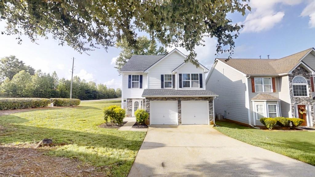 Welcome to this beautifully maintained 3-bedroom, 2.5-bath home located in the sought-after Ashley Place community. Featuring Luxury Vinyl Plank flooring throughout the main floor, with fresh paint throughout the entire house, this home offers both style and comfort. The inviting family room includes a cozy fireplace, perfect for relaxing evenings. The kitchen showcases classic white cabinets and provides a functional layout for cooking and entertaining. Upstairs, you'll find plush carpeting, a spacious primary suite with a large bath, and a versatile bonus area at the top of the stairs ideal for a game room, home office, or additional living space. Step outside to a private, fenced backyard with a rear patio perfect for entertaining, gardening, or simply enjoying your own outdoor retreat. Conveniently located near schools, shopping, and with easy access to I-20, this home offers the perfect blend of comfort and convenience.