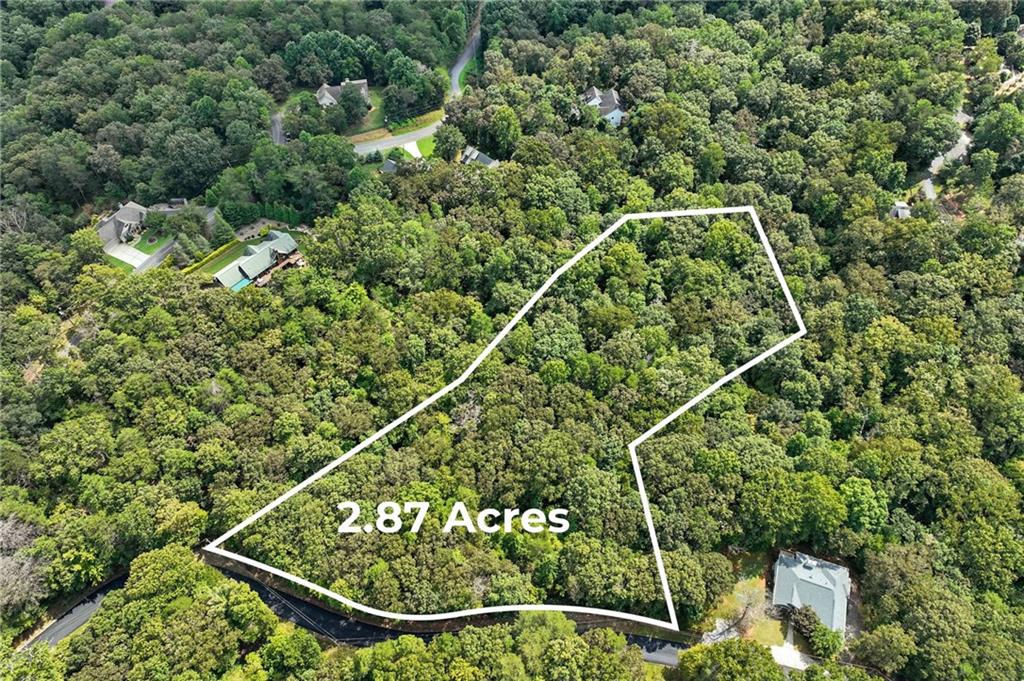 2.87 ACRES OF PRIVATE, WOODED LAND! This beautiful property offers the perfect blend of seclusion and convenience. Tucked away in a serene, wooded setting, it provides the ultimate escape while remaining just minutes from all the amenities you need. Enjoy easy access to GA-400, making your commute a breeze. You'll be close to a variety of shopping and dining , as well as the local hospital.
The land features a small, tranquil stream and paved road frontage, adding to its appeal and accessibility. This is a rare opportunity to build your dream home in a private, natural environment without sacrificing a convenient location. Don't miss out on this exceptional piece of property!