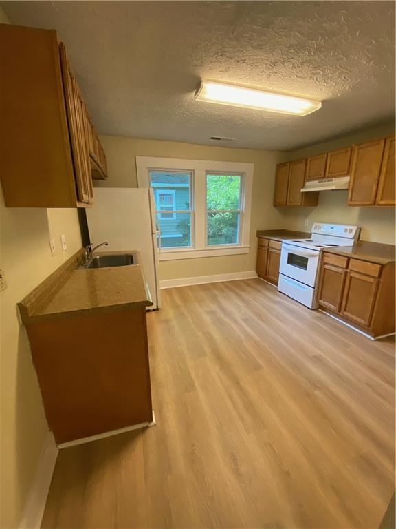 Sweet & Sassy Bungalow-Step onto the rocking chair front porch and into this bright and inviting home filled with historic charm and modern updates. Gleaming wood floors, abundant windows, and thoughtful touches make this home as charming as a Southern belle with a smart contemporary twist. Inside, you’ll find 4 spacious bedrooms, an updated kitchen and bath, plus a full walk-in laundry room. The kitchen and bath blend modern style with timeless character, creating a warm, welcoming vibe throughout. Out back, enjoy a fenced yard and outdoor deck—perfect for a laid-back BBQ, entertaining friends, or simply relaxing under the stars. This bungalow has it all: character, comfort, and the perfect mix of old and new. Truly is a peaceful, cozy sanctuary located minutes from the airport, Downtown Pittsburg Yards, the Atlanta beltline South Trail, Grant Park, Summerhill, and the Lee and White development and food hall in West End.