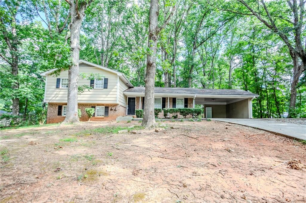Nestled on a generous lot, this split-level home presents a versatile layout with room to grow. Multiple living areas across two levels offer flexibility for gathering, entertaining, or creating a dedicated office or guest suite. The separate dining area, spacious kitchen, and cozy den provide a practical and functional flow. A covered carport and private backyard add convenience and outdoor potential. Whether you’re looking for a home to personalize or an investment opportunity, this property delivers space and value in a well-situated location.
