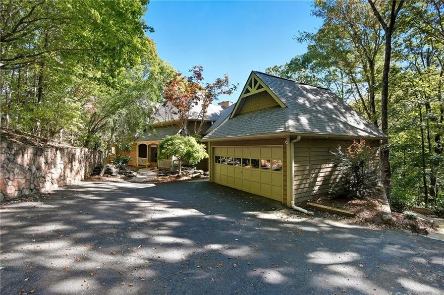 Completely reimagined for longevity and modern comfort, this 3 acre private residence showcases recent renovations designed to last for generations—including fully rebuilt back decks supported by steel piers, custom stone retaining walls along the driveway, a new roof (November 2022), and new windows installed within the past four years. ALL FURNITURE CONVEYS. Inside, a new gas fireplace now anchors the great room, with the option to extend the gas line to the kitchen for a future gas range. Every bathroom has been thoughtfully renovated within the past four years, ensuring a cohesive, move-in-ready experience throughout. Even the exterior has been carefully maintained, with screens placed over the front water features for the fall and winter seasons. Set on Creek 6 golf green, this beautifully updated 5-bedroom, 5.5-bath home perfectly blends mountain elegance with enduring craftsmanship. Surrounded by mature hardwoods and thoughtful landscaping, the property offers both privacy and presence, featuring stone pathways that wind through the grounds and two tranquil water features welcoming you home. The primary suite on the main level is a true retreat, complete with a bonus room—ideal as an office, nursery, or fitness space—and a spa-inspired bath with soaking tub, tiled walk-in shower, and spacious closet. The great room features two-story ceilings, a floor-to-ceiling stone fireplace, and walls of windows showcasing breathtaking forest views. From here, step into the heated and cooled sunroom, a glass-wrapped sanctuary among the trees, or relax on the screened-in porch and multiple decks designed for effortless indoor-outdoor living. The expansive kitchen provides generous counter space for the chef of the house, while beautiful hardwood floors set a warm, refined tone across the main level. Upstairs, two spacious bedrooms each offer private decks and renovated ensuite baths, connected by a cozy loft perfect for reading or quiet reflection. On the terrace level, enjoy a second living area with wet bar and a versatile bunk room/flex space with custom built-ins—ideal for guests or creative pursuits. With its rare 3-acre setting, enduring updates, and panoramic views of the Creek course, this home stands among Big Canoe’s most distinctive offerings—where luxury and longevity meet in perfect balance. Big Canoe spans 8,000 acres, with over one-third preserved as parks and green space, and is certified as a Nature Preserve by Georgia Audubon. Residents enjoy access to golf, tennis, pickleball, bocce, a 13,000-square-foot Wellness Center, dog parks, playgrounds, lakes, and 25 miles of scenic hiking trails—with flexible membership options or pay-as-you-go access. Buyer to verify all information and dimensions deemed important.
