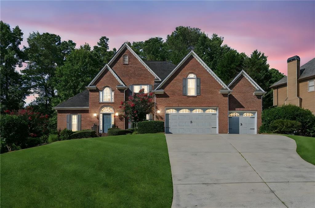 Move right into this magazine-worthy home located on a quiet cul-de-sac lot. Loaded with curb appeal, this brick home welcomes you inside to an open floor plan with gleaming hardwoods, vaulted ceilings, exquisite trim work, and plenty of natural light. The two story family room invites you to stay awhile. The fully updated kitchen features quartz countertops, stainless steel appliances, and a custom pantry with plenty of storage. The breakfast nook overlooks the private and landscaped backyard and leads to a year round sunroom and back deck. The primary bedroom is on the main level with its own access to the sunroom as well as a luxurious ensuite and walk in closet. An additional bedroom on the main is perfect for guests, family, or a home office. Upstairs you will find three additional bedrooms, a full bathroom, and a huge bonus room. The finished terrace level is a complete apartment with a bedroom, full bathroom, kitchen, living space, bonus room, and its own secondary driveway, patio, and entrance. There is an abundance of storage in this home from the three car garage, unfinished space in the basement, workshop, and attic space. Award winning schools and convenient location make this home desirable. Don't miss your opportunity to call it home.