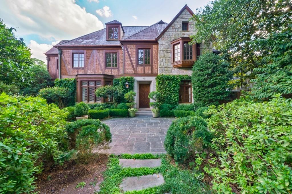 Beautiful English Tudor home in sought-after Haynes Manor. Thoughtfully designed by Pak Heydt, this charming home offers oversized living spaces, ideal for entertaining. Architectural details throughout include wooden beams, leaded glass windows, coffered ceilings and incredible woodwork. Floorplan includes formal living room, dining room and handsome wood paneled den. Kitchen offers granite counters, island, stainless steel appliances, opens to the breakfast room & keeping room with French doors leading to the covered porch. Upper level staircase leads to oversized master suite with walk-in closet and luxurious master bath. Upper level also hosts 3 secondary bedrooms with en-suite baths. Finished terrace level offers media room, bedroom, 2 full baths and access to the 2 car garage. Lovely manicured grounds include mature landscaping, pool, fountain and outdoor grilling area.