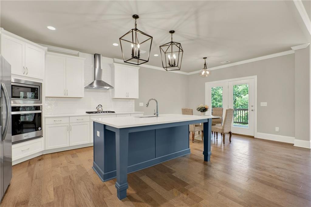 Welcome to this stunning 5-bedroom, 4-bathroom home built in 2022, offering modern elegance, thoughtful design, and a peaceful wooded backdrop with a creek running through the backyard.
Step into the open foyer—offset to the formal dining room—and enjoy spacious living areas with hardwood floors, crown molding, and bay windows that fill the home with natural light. The formal dining room is set apart from the main living areas, creating a more defined and traditional entertaining space.
The white-on-white kitchen features quartz countertops, stainless steel appliances, and a large island, all opening to the bright and inviting living room and breakfast area.
A bedroom with a full bath on the main level is perfect for guests or multi-generational living. Upstairs, a spacious bonus room adds flexibility, while a Jack and Jill bathroom with a double vanity connects two secondary bedrooms. The primary suite is a luxurious retreat with double tray ceilings and a spa-like en suite featuring a soaking tub, oversized tiled shower, double vanities, and enormous his-and-hers walk-in closets.
Enjoy outdoor living on the covered back deck with ceiling fans or step down to a second deck off the basement—ideal for enjoying the serene creek and wooded views.
Additional highlights include a tile-floor laundry room, insulated garage doors, tankless water heater, and a full basement offering room to grow.
This home blends comfort, quality, and privacy—perfect for modern living in a tranquil setting.