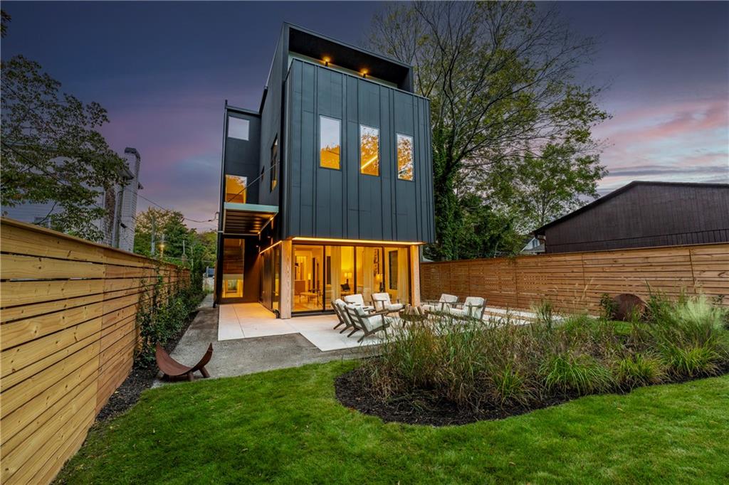 Stunning Brand-New Modern Home just Steps from the Beltline in Virginia-Highland
5 Bedrooms | 4.5 Bathrooms | 4 Levels | Rooftop Deck | Private Fenced Yard
Perfectly positioned just steps from the Beltline, Ponce City Market, and Virginia-Highland, this striking new modern home blends architectural sophistication with warm, livable design. Spanning four finished levels, it offers a rare balance of luxury, light, and functionality in one of Atlanta’s most walkable neighborhoods.
The open main level welcomes you with wide-plank oak flooring, 11-foot ceilings, and a seamless flow between the living, dining, and kitchen areas. The dining room is framed by floor-to-ceiling windows and elegant brass fixtures, while the chef’s kitchen features a large island, custom cabinetry, Dekton porcelain countertops, and matte black finishes. The kitchen is equipped with a 36-inch Z-Line dual-fuel range with six sealed Italian burners, a Sharp 24-inch microwave drawer, and a GE dishwasher. Both the main living area and the top-floor bonus room are pre-stubbed for fireplaces.
Expansive sliding glass doors connect the interior to a private, fenced backyard, creating effortless indoor-outdoor living. The patio features sleek concrete finishes and landscaped greenery, offering a tranquil retreat with alley access for added convenience.
Upstairs, the primary suite serves as a private sanctuary with oversized windows, a spa-inspired bath, soaking tub, and glass-enclosed shower. Additional bedrooms and bathrooms are spacious and bright, designed with clean lines and modern fixtures.
The lower level provides a flexible space ideal for a guest suite, gym, or media room, complete with a built-in wet bar and extra storage. The top floor adds a fifth bedroom and full bath, along with a large bonus room featuring a full wet bar and direct access to a rooftop deck perfect for entertaining. From here, enjoy views of the tops of city buildings surrounded by lush trees and the beautiful Virginia-Highland neighborhood landscape.
Highlighted Features:
5 bedrooms, 4.5 bathrooms across four thoughtfully designed levels
11-foot ceilings on main, 10.5-foot ceilings on bedroom level
Chef’s kitchen with Dekton porcelain countertops, custom cabinetry, and premium appliances
Dining room with floor-to-ceiling windows and designer lighting
Seamless indoor-outdoor living with sliding doors to private fenced backyard and patio
Professionally landscaped yard with alley access
Spa-style primary suite with soaking tub and glass shower
Lower-level flex suite with wet bar and storage
Top-floor fifth bedroom, bonus room, and full wet bar with rooftop deck access
Rooftop views of treetops and the tops of city buildings
Driveway parking and architectural exterior lighting
Steps from the Beltline, Ponce City Market, and Virginia-Highland
787 Bonaventure Avenue combines striking modern architecture with natural warmth and thoughtful functionality, offering the best of design and location in the heart of Atlanta’s most vibrant community.