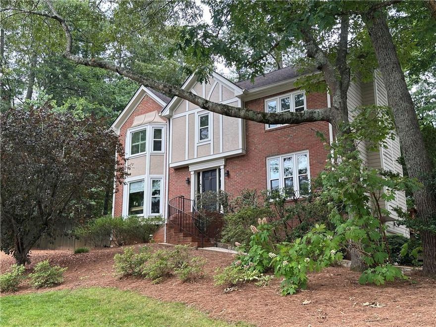East Cobb Gem with Great Potential! Welcome to 3298 Robinson Oaks Way NE, where quality and timeless charm meet in the heart of East Cobb. This meticulously maintained four-bedroom, two and a half-bath home offers 3,230+/- square feet of beautifully updated living space in a peaceful, optional-HOA community with easy access to Pope High School and Hightower Trail Middle School. Venture inside to find new hardwood floors in the foyer and den, a warm and inviting kitchen with granite countertops, tile flooring, and stainless steel appliances including a gas cooktop, oven, microwave, and refrigerator. The living and dining rooms have light and bright windows with ample space for entertaining. The living room would make a perfect office space for someone who works from home as it does have a door for privacy. Upstairs, you'll love the updated primary bathroom with granite counters, new fixtures, and heated tile floors - complete with a large glass enclosed shower and a soaking tub. The hallway bathroom for the secondary bedrooms has a vanity area with a door to the shower and toilet space. Most rooms feature plantation shutters and the house has new windows for energy efficiency and style. The finished basement includes an office along with a second office space outfitted with a clothes rack perfect for remote work or additional storage. The drive under garage has ample space for additional storage as well. Outside, enjoy your private retreat with new stonework along the walkway and driveway, a custom stone patio with fireplace, lush new landscaping including azaleas and Leland cypresses. Located in the highly sought-after East Cobb area, this home offers easy access to top schools, parks, and shopping.