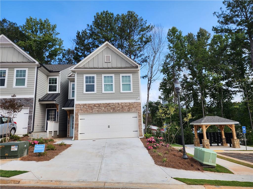 Don't miss out on this brand new 3 bed 2.5 bath Townhome located in Holly Springs. Located mins from I-575 and only 1 exit from the Outlet Shoppes at Atlanta located off Ridgewalk Pkwy. The kitchen features a beautiful quartz island, grey tiled backsplash, stainless steel appliances and provides a view of the family room. Family room features an upgraded digital fireplace and ceiling fan. Huge primary bedroom with trey ceilings and plenty of closet space. Primary bath features a double vanity and shower/tub combo. Refrigerator and bathroom mirrors are being added before move-in.