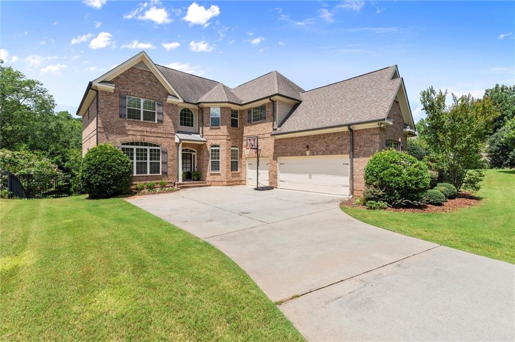 Absolutely phenomenal executive home in the highly sought-after Pope High School district, nestled within a quiet boutique neighborhood on a beautifully landscaped ¾-acre lot. Enjoy complete privacy and a spacious backyard with plenty of flat lawn — perfect for outdoor fun, pets, or future pool plans.
This impeccably maintained home blends timeless style with everyday functionality. At its heart is a bright, open-concept kitchen featuring a large center island, walk-in pantry, and effortless flow into the living space — perfect for entertaining and family life. A stunning double-sided stone fireplace anchors both living areas, creating warmth and character throughout the main level.
Additional main-floor highlights include rich hardwood floors, abundant natural light, a dedicated home office, and a stylish dining room. A guest suite on the main level adds flexibility for visitors or multigenerational living.
Upstairs, the spacious primary suite offers a serene retreat with a cozy sitting area, spa-like bathroom with walk-in shower and soaking tub, and an oversized walk-in closet. Three additional bedrooms include one en-suite and a Jack-and-Jill, each with generous closet space. A large media or bonus room provides the perfect space for movie nights, a playroom, or homework zone. Brand new carpet was just installed throughout the upper level.
Step outside to enjoy the peaceful screened-in porch, grilling deck, and lower-level patio — all overlooking a fully fenced, flat backyard oasis.
A spacious 3-car garage completes this exceptional property.