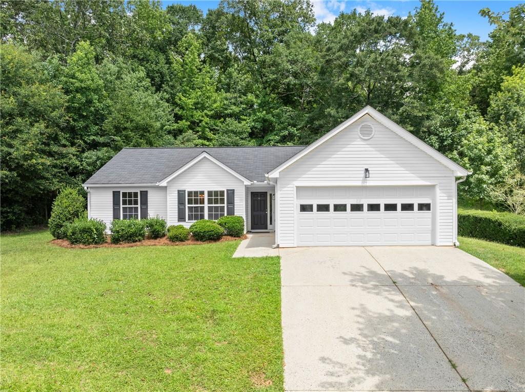 This 3-bedroom, 2-bathroom home is located in the quiet, established Flanagan Mill Estates community, where large lots and no HOA fees give you extra flexibility and privacy. Inside, you’ll find all-new luxury vinyl plank flooring throughout, freshly painted walls and trim, and updated light fixtures in every room. The kitchen features newer stainless steel appliances and an upgraded sink, while both bathrooms have been refreshed with new vanities and flooring. The spacious primary suite includes a walk-in closet and a large ensuite with a double vanity, soaking tub, and separate shower. Two additional bedrooms, a full guest bath, laundry room, and a 2-car garage provide a practical layout that fits a variety of needs. The private backyard offers plenty of room to relax, garden, or entertain. The home is USDA loan eligible and tucked away in a peaceful neighborhood, yet just minutes from schools, shopping, and dining. Set on over a half acre, this move-in-ready property is ideal for buyers looking for space, updates, and a quiet setting without the restrictions of a HOA.