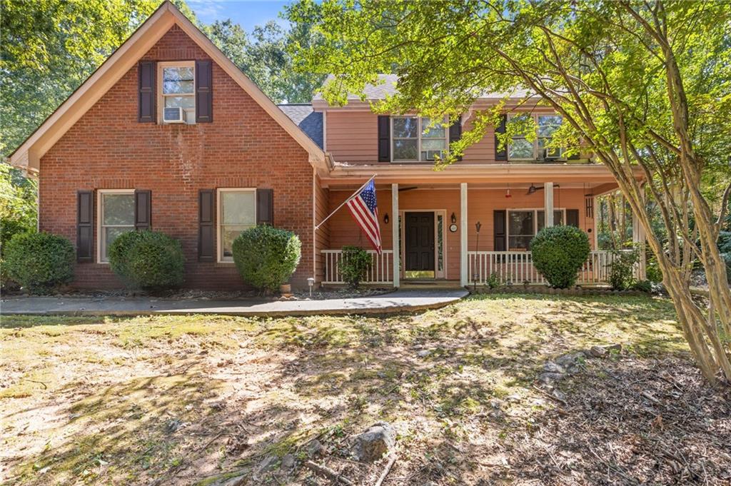 Welcome home to a place full of charm and possibility. Nestled in a peaceful, one-street neighborhood, this home invites you in with its welcoming front porch and family-friendly atmosphere. Inside, the open flow makes gathering easy, with the kitchen at the heart of it all—overlooking the cozy and spacious family room with its brick fireplace, the sunny breakfast nook, and the formal dining room ready for special occasions. A flexible main-level room offers space for a home office, playroom, or formal living area, along with a convenient powder bath. Upstairs, four spacious bedrooms provide room for everyone, including a generous bonus/bedroom and a primary suite with its own private bath. The laundry room is also thoughtfully located upstairs, making daily routines a breeze. Life here is quiet, peaceful, and connected. Enjoy evenings on the covered porch, wave to neighbors on a stroll, and take comfort in the close-knit feel of this established community. At the same time, you’re just minutes from Hwy 316, shopping, dining, and schools—offering the best of both rural tranquility and everyday convenience. Priced with room for updates, this home is a rare opportunity to create the perfect space to fit your vision, while already enjoying the value of this desirable neighborhood. BRAND NEW CENTRAL HVAC UNITS-Window units in photos are being removed. Priced under comps and sold AS-IS, with exterior siding/trim updates needed, the potential here is endless.