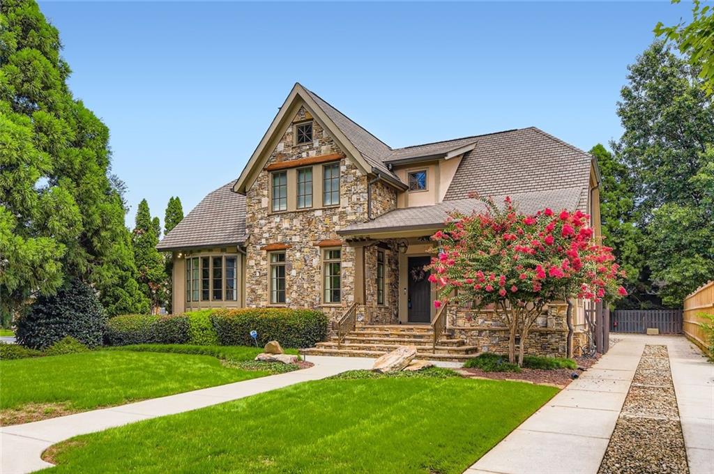 Picture-Perfect Luxury in Prime East Lake Location! Classic design meets modern sophistication in this immaculate 4BR/3.5BA showcase home, built by renowned Woodward Rhodes and located just steps from East Lake Golf Club and within Tier 1 for Drew Charter School. This previous model home/entertainer's dream features a flowing open floor plan filled with natural light, high-end designer finishes installed by HGTV and luxe details throughout - hardwood floors, crown molding, plantation shutters, stunning two-sided fireplace connecting the dining room and living room with additional one in the vaulted great room. The eat-in kitchen shines with stainless steel appliances, granite countertops, spacious cabinets, butler's pantry, wine rack and breakfast bar - all open to the great room. Main level primary suite offers a spa-like bath, custom walk-in closet and plenty of light. Lots of storage including pull down attic stair area and four walk-in attic storage spaces in two guest bedrooms! Additional feature are the not to be missed Norman Top Down Bottom Up Honeycomb cordless shades with blackout features as well - srteamlined, safe, and multi-purposed. Enjoy a charming rocking chair front porch, a vaulted stone floor screened-in porch connecting to the garage - don't miss the finished bonus room above! Professionally landscaped, fenced back yard and gated driveway. Moments to 2nd & Hosea, Oakhurst Village, Kirkwood, Decatur, Pullman Yards and more - plus quick access to I-20. This East Lake gem truly has it all!