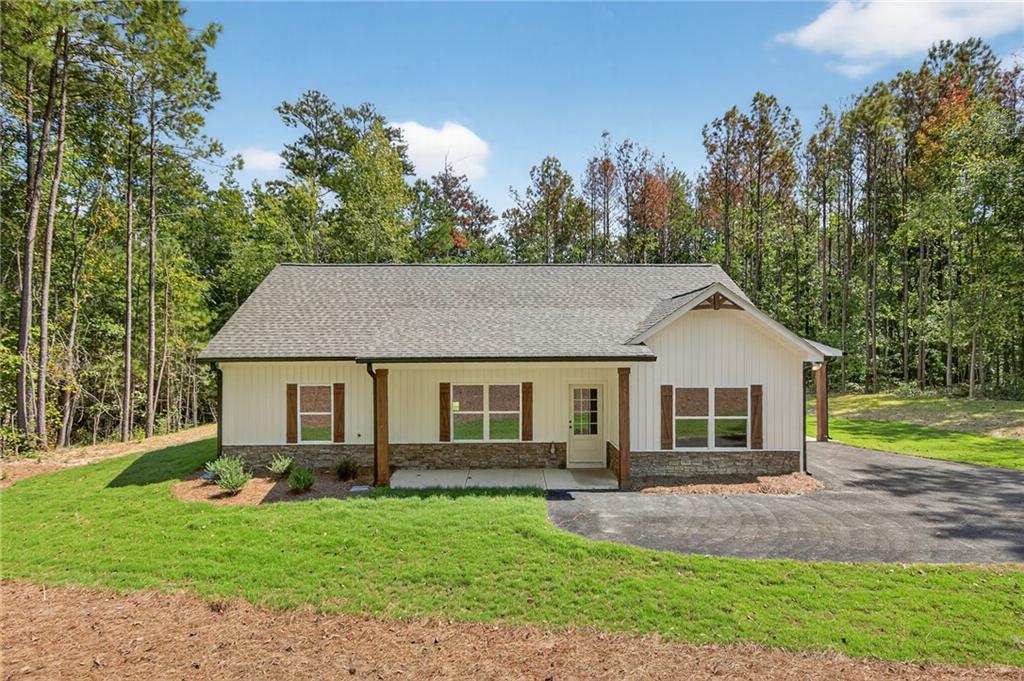 Construction is COMPLETED! Do not miss your chance to own a 0.75-acre lot with NO HOA! This gorgeous step-less RANCH home boasts an open-concept design with a spacious VAULTED family room. The gourmet kitchen features GRANITE countertops, a FARMHOUSE SINK, a large PANTRY, and stainless steel appliances, perfect for entertaining. The large master suite offers a private retreat with a beautiful ensuite bathroom featuring a double vanity, custom TILE SHOWER & a generous walk-in closet. Two generously sized secondary bedrooms offer ample storage space with large closets, complemented by a stylish full bathroom. Step outside to the covered back patio for your morning coffee, or relax on the rocking chair front porch. The CARPORT is an added convenience for all of your outdoor needs. Standard features include beautiful luxury LVP in the kitchen, living room, entry, and baths; plush carpeting in the bedrooms; and high-quality finishes throughout. Enjoy the freedom of a PRIVATE LOT with no HOA restrictions, combining tranquility with convenient access. Minutes to Rockmart, Dallas, & Hiram! Please be sure to ask about our incentives, using the seller's approved lender, Gareth Thomas, with Silverton Mortgage. Not quite the right floor plan? We have other options & LOTS available! Contact us today for further details!