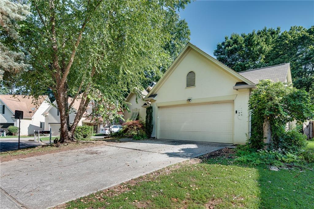 Set on a quiet cul-de-sac in the Morton Chase neighborhood, this well-maintained one-level home offers a comfortable and flexible layout in a highly convenient Alpharetta location. With 4 bedrooms and 3 full bathrooms, the home features an open living area with vaulted ceilings, new flooring, and a bright kitchen with white cabinetry and a breakfast bar. The living room centers around a cozy fireplace and flows easily into the dining space. The primary suite includes a walk-in closet, double vanities, soaking tub, and separate shower. A custom fourth bedroom suite at the rear of the home offers added privacy, with its own bath, walk-in closet, and direct access to the covered patio — ideal for guests, extended family, or a quiet workspace. Outside, the fenced backyard includes an extended covered patio with ceiling fan, offering a peaceful spot to enjoy the outdoors in any season. A 2-car garage and low-maintenance lot round out the property. Located just minutes from GA-400, Avalon, parks, and top-rated schools, this home is a great option for those seeking practicality, comfort, and location — all in one.