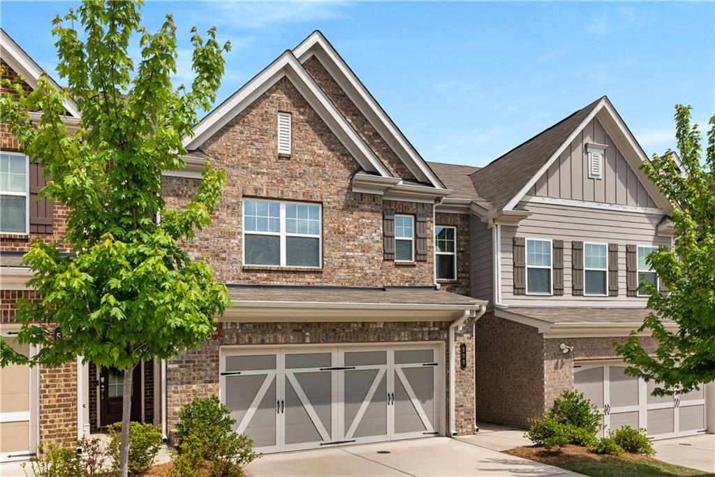 INCREDIBLY IMMACULATE TOWNHOME IN SOUGHT AFTER PROMENADE AT THE SQUARE! This practically NEW townhome is conveniently located just minutes from Marietta Square! This gorgeous craftsman style brick and hardy plank home is turn-key and easy living at its finest! The beautiful 2-story foyer invites you into the Open Concept floorpan with lots of living space and storage! Beautiful hardwood floors flow throughout the main level from the front door and lead you into the heart of the home! The Chef's kitchen offers stainless steel appliances, lovely stone countertops, extra tall cabinets for storage, ceramic tile backsplash and a huge center island made for gatherings of any size! Wait until you see the walk-in pantry- tons of space for the warehouse shoppers in all of us! The fireside living room allows this open space to function seamlessly with lots of company or to become a warm and cozy spot just for you! Just outside the dining space, you'll find the backyard that all townhome owners wish they had! You have your own patio and fenced-in grassy yard! The homeowners have linked a few yards together to allow dogs or little ones to mingle or to kick a ball around together. Easily convert this Private yard to a smaller even more Private yard if desired.  
Upstairs, you'll find the primary suite with walk-in closet and ensuite, as well as 2 spacious secondary bedrooms along with a secondary bathroom and a large loft that can serve whatever purpose you desire... office, upstairs den, playroom, yoga room, crafts... the list goes on. Amazing location and a wonderful community with neighborhood pool and located just next door to the Marietta City Golf Club! Come check it out! Showings start Friday at 5pm.