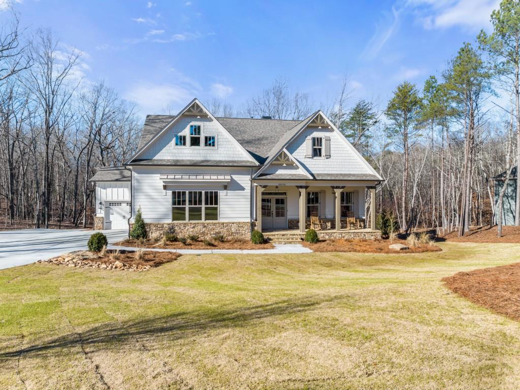 New Construction home with no HOA & light covenants! One of six new estate lots close to Lake Lanier. Spacious Oconee Plan on a full basement. 4 bed/4.5 bath on 2 acres with Corps/Lake Lanier frontage. Highly desired East Forsyth school district. Home features many upgrades! Primary bedroom on the main floor with en-suite bath and his & her vanities. Large bedroom/office with private bath on the main floor. Limestone fireplace in the living room. The kitchen has stainless steel appliances and a walk-in pantry. Attached 3 car garage and a wonderful yard for entertaining or adding a pool. Seasonal lake view from the deck. Walk down your private wooded trail to Lake Lanier! Take a tour of your dream home today!