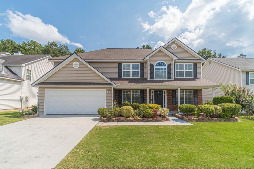 Lovely home in Snellville ready for a new owner. Two-story home with brand new luxury vinyl plank flooring throughout the first floor. Formal living and dining rooms. The living room would make a perfect home office. There is a bedroom plus a full bath on the first floor. Sunken family room with a fireplace views the gorgeous backyard. The large kitchen has a lot of cabinets, plus a center island and a corner pantry. There is a stainless refrigerator plus all new gas range, microwave, and dishwasher! Upstairs, there is a huge primary suite with a sitting room and luxurious bathroom. You will find two additional bedrooms upstairs, plus a loft, which would make a fun playroom or upstairs den. The interior of the home has a fresh coat of paint in a light neutral color. Outside, you will find easy maintenance vinyl siding. The owner of this home was a great gardener, and she has lots of gorgeous plants and trees in the front and back yard. The rear yard is fully fenced.