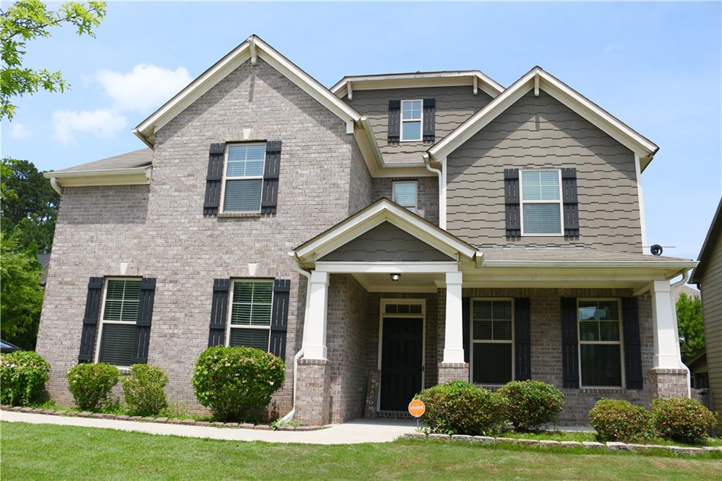 Refrigerator, Washer & Dryer Included. Brick Front Beauty on Corner Lot with A Bedroom & Full Bath on Main! This stunning 4-bedroom, 3-full-bath with loft home offering the perfect blend of comfort and functionality. Nestled on a fenced corner lot with a side-entry garage, this home greets you with timeless curb appeal and a charming front porch. Step inside the elegant 2-story home to find formal living and dining rooms enhanced by coffered ceilings and craftsman-style trim details. The island kitchen seamlessly opens to the family room, where a stacked stone corner fireplace and an abundance of natural light create the perfect gathering space. A bedroom and full bath on the main level offer convenience and flexibility for guests or multi-generational living. Upstairs, you’ll be wowed by the oversized loft – ideal as a second living room, media room, or play area. Retreat to the massive primary suite, complete with a sitting area, ENORMOUS walk-in closets, and a spa-like bath featuring a double vanity, tiled shower with glass enclosure, and plenty of space to unwind. Every bedroom includes walk-in closets, and a second oversized bedroom with sitting area feels like another primary suite. Enjoy outdoor living on the covered back patio and spacious fenced yard – perfect for relaxing or entertaining.
