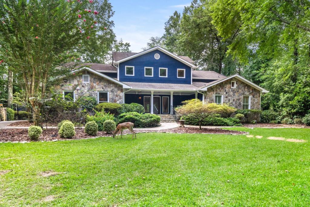 Welcome to your own pristine sanctuary situated a short drive north of Atlanta. Enveloped in nature, this bewitching 2+ acre property sits on the Chattahoochee river surrounded by wildlife, deer, flora, and privacy. The owners have lovingly updated the home immaculately, including a gorgeous new kitchen with 72-inch wolf range, Sub-Zero refrigerator, large jewel toned island with seating, pot filler, and built-in wine fridge. Two secondary bathrooms have been impeccably updated this year, with no detail left untouched, all brand-new vanities, showers, tile, and fixtures. Primary suite boasts a large sunlit office with built-ins in the back of home, a steam shower, large closets, and plenty of storage in the recently renovated bathroom (2018). A sizeable screened in balcony and upper deck was added to further connect you to the outdoors from the upper level of home. Whole home updates include all new and refinished floors, fresh paint throughout, shiplap, two new HVACs, and tankless water heater. Open your new sundrenched 8 ft French doors to your verandah and expansive views of your river lot, sounds of flowing water as it runs down the new river rock water fall into your saltwater, Pebble-tech, and heated pool that runs almost the entire length of the home. Two structures on the property to add supplementary storage, or could be easily finished off for a workshop, she-shed, or additional living space. Sip wine in your six-person hot tub overlooking the Chattahoochee, relax by the built-in fire pit area, or take a kayak out from your own personal dock on the river. Located in the coveted Centennial school district, walking distance to River Eves Elementary, and nearby Don White and Roswell Riverside park and trails, and recreation centers. Close to highway 400, shopping, retail and Roswell's shops/restaurants. (The deer in photos are real and do convey with property :)