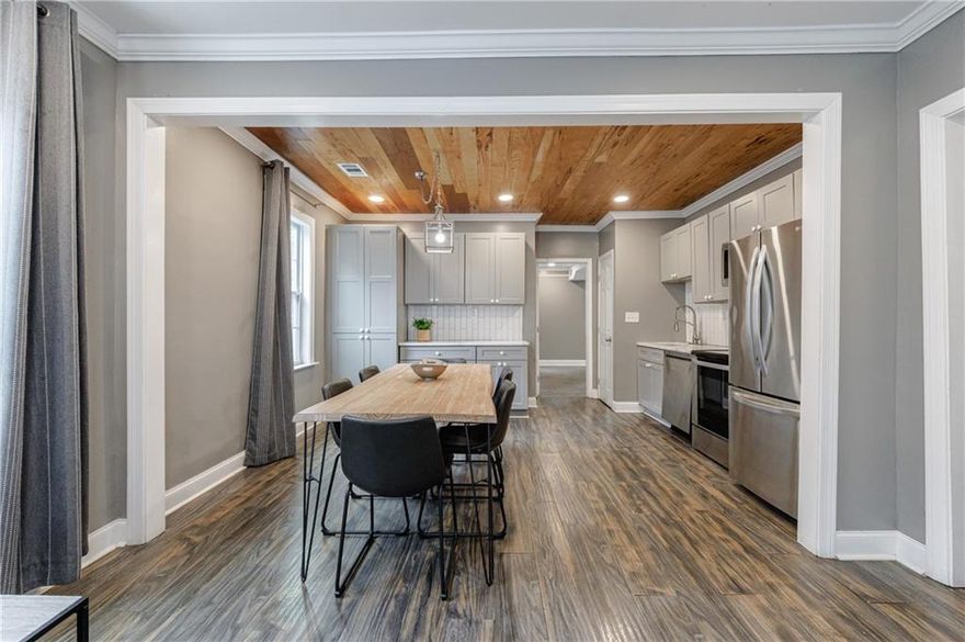 Fantastic fully renovated, turnkey 3/2 gem in the heart of Historic Washington Park neighborhood, 0.1 miles to the Atlanta Beltline Westside Trail & 33-mile trail network. Welcome Home to 1012 Westmoor Drive! Upon entry you are met w/ an inviting entertainer’s open concept floor plan w/ family room w/ electric fireplace open to dining & eat-in chef’s kitchen w/ custom cabinetry, subway tile backsplash, stone counters & stainless appliance suite. To-the-studs renovation in 2020: New mechanical (electrical, plumbing, hvac & water heater) + New roof, windows, kitchen & baths. Wide-plank hardwood flooring, ceiling fans & recessed lighting throughout. Thoughtfully curated floor plan w/ guest wing w/ 2 generous-sized bedrooms separated by a full hall bath w/ soaking tub. Convenient hall laundry. Tranquil primary retreat w/ sitting area, spa-like bath w/ large walk-in shower, spacious walk-in closet & sliding glass door leading to your private rear deck & flat, walk-out fenced backyard. Situated in a rapidly developing area of Metro Atlanta, 1012 Westmoor Drive is ideal for both owner-occupants & investors alike w/ robust investment income potential (short-term rental/Airbnb w/ the upcoming 2026 FIFA World Cup & Centennial Yards 50-acre, $5B project in Downtown Atlanta w/ retail, office & hospitality spaces). Prime location, minutes to Downtown, Georgia Tech, West Midtown, Mercedes-Benz Stadium, State Farm Arena & I-20/85.