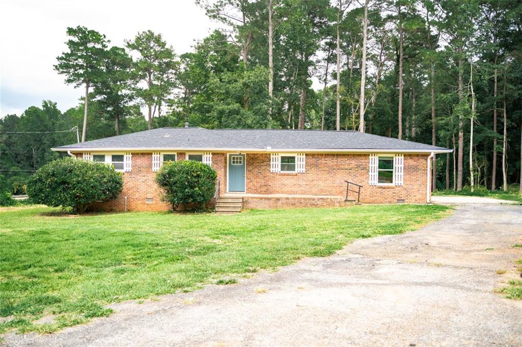 Welcome Home! This home features 3 beds/ 2 baths, 4 sided brick on a large 1.76 Acre private lot. MANY RENOVATIONS less than 4 years old include NEW HVAC system heat & air including NEW ductwork, NEW architectural roof, NEW gutters, NEW stainless appliances, NEW kitchen cabinets, NEW granite countertops, NEW flooring, NEW interior doors, baseboards and trim throughout, NEW lighting fixtures, NEW water heater, NEW tub/shower, vanity and toilet and FRESH paint, NEW plumbing and NEW windows! Conveniently located only 15 miles to Atlanta. Easy access to both 285 and 675. Large lot + recent removal of 30+ trees and grass seeds sewn. Create your own piece of paradise! Looking for a property where you could have your own little homestead? This could be your dream come true!