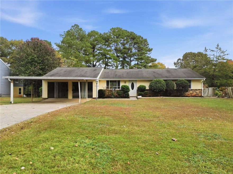 Fantastic ranch home just off Sandy Plains Road in Marietta. This 4-bed, 2-bath ranch is located in the highly sought-after Sprayberry school district. You’ll walk into the main living space that combines the living room and dining room. The kitchen and laundry closet are tucked just behind the dining area. To the right, you’ll find the bedrooms: a master suite plus two additional bedrooms sharing the other full bath. On the opposite side of the home, there is a separate family room with a fireplace for a cozy feel. A large bonus room could serve as a fourth bedroom. Other highlights include a level lot, covered back patio, and a two-car carport.