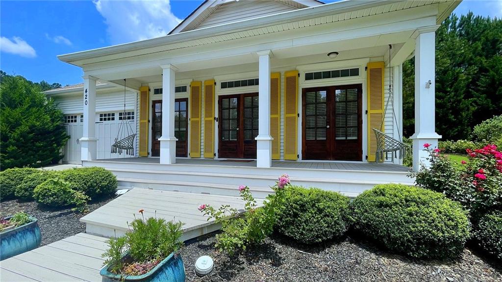 Rare opportunity to own this stunning Custom Coastal Designer Craftsman-Style Cottage, featured on FOX's hit show HOME FREE with Mike Holmes and Tim Tebow! Located in the highly sought-after Oakleigh Pointe community with resort-style amenities and within the desirable East Paulding School District, this unique home offers exceptional charm and design. A true Southern welcome awaits with an oversized rocking chair front porch featuring three sets of shutter-wrapped transom double French doors and grand columned detailing. Inside, you'll find an open-concept layout with 9' ceilings, coastal-inspired whitewashed wood accent walls, rich hardwood floors, recessed lighting, a cozy sitting area, separate dining room, fireside family room with a gas log fireplace, and a home office. The chef's kitchen is a showstopper with matte quartz countertops, farmhouse sink, white cabinetry, designer vent hood, custom wood island, stainless steel appliances including a gas range, and a pot filler. The spacious owner's suite boasts built-in wardrobes, a spa-inspired ensuite with a clawfoot tub, rainfall showerhead, tile flooring, and a French door leading to a private outdoor pet spa. A mudroom and landing area off the kitchen lead to a serene backyard oasis complete with a private flagstone patio and cobblestone fire pit, and an outdoor TV perfect for entertaining. A guest bedroom, full bath, and 2-car garage complete this exceptional home. Endless hot water and energy efficient with a tankless water heater! Ideally located near top-rated schools, dining, shopping, and just minutes from Downtown Acworth, Dallas, Brookstone Golf & Country Club, Lake Allatoona, and Red Top Mountain Park. Don't miss this one-of-a-kind home, schedule your private tour today! Special Buyer Incentives Available! Take advantage of the Buy Before You Sell Program, enjoy a one-year temporary rate buydown (1% below market rate) OR a closing credit at no cost to the buyer, courtesy of Mark Baker/SWBC Mortgage.