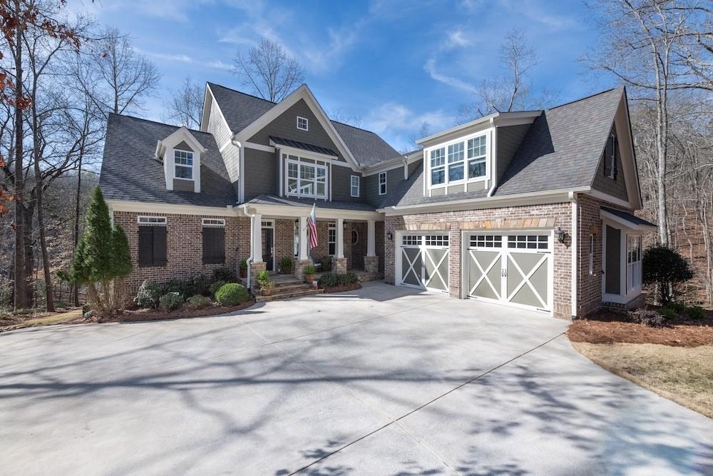 **JUST STEPS AWAY FROM THE WATER! The lake is just out your backdoor!** This CUSTOM-BUILT home has all the LUXURY, THOUGHTFUL DETAILS you would expect off the lake, but includes LAKE LIFE at an UNBEATABLE PRICE.**There aren't many turn-key homes so close to the water in this price range,** The light-filled kitchen is a CHEF’S DREAM and is equipped with SOFT-CLOSE CABINETS and stainless steel appliances and is open to the 11 FOOT-CEILING FAMILY ROOM. Both gathering spaces, as well as the PRIMARY SUITE ON THE MAIN FLOOR, have LAKE VIEWS to enjoy all day. Even at night, lights reflect off the water for a serene ambiance as you wind down. The home is built away from other homes in the CULDESAC, ensuring a feeling of PRIVACY and seclusion. LAUNCH YOUR KAYAK right out the back door, FISH over 350 feet of UNOBSTRUCTED SHORELINE, or make the SHORT EASY WALK to your DEEDED, PERSONAL BOAT SLIP with HYDROHOIST on the COMMUNITY DOCK. (This is ONE OF ONLY TWO HOMES in Lighthouse Harbor with DIRECT ACCESS to the dock via a PRIVATE TRAIL. Other dock owners must use a shared path from elsewhere in the neighborhood.) The location of the dock offers CALM WATER, with MINIMAL BOAT TRAFFIC AND LITTLE WAKE—perfect for SAFE SWIMMING, FLOATING, and keeping your boat protected from wave damage. The dock also has SECURITY CAMERAS and is treated monthly with SPIDER AWAY. There are plenty of options for entertainment for your friends and family, from two SPACIOUS PORCHES where you can watch HERONS land on the lake, see DEER, and listen to the BABBLING BROOK in the woods. Entertainment spaces within the home also include a MOVIE ROOM and a huge, sunlit, STUBBED-OUT TERRACE LEVEL! The HIGH-CEILING TERRACE LEVEL BASEMENT enhances the home’s spacious feel and provides ample opportunity for expansion. And don't forget the NEIGHBORHOOD POOL and CLUBHOUSE just around the corner from Nantucket Cove. Want a private pool in your own backyard? We have confirmed there is room! In addition to LARGE BEDROOMS throughout the house, there is a NANNY'S QUARTERS or ADDITIONAL FLEX SPACE with SECOND LAUNDRY UPSTAIRS. DON'T MISS YOUR CHANCE TO OWN THIS GEM! Be sure to watch the virtual video tour!