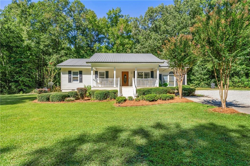LOCATION, LOCATION, LOCATION! WELCOME HOME to this charming 4 Bedroom, 2 Bathroom Ranch nestled on 1.5 acres just minutes from Lake Oconee and near the highly sought out Lake Oconee Academy! Surrounded by nature and bordered entirely by 1500 acres of US forestland offering hunting and fishing opportunities in your backyard. This beautiful home offers the perfect serene oasis with plenty of space to unwind, including a covered front porch and large rear deck! Step inside to a bright living room with an open concept to the kitchen, featuring hardwood flooring, stainless steel appliances, and an eat-in area. Just beyond the kitchen, the cozy sunroom offers the perfect spot for dining or relaxing, while the versatile bonus room can be used as an office, playroom, family room, or anything that is perfectly tailored to your family's lifestyle!!! Down the hall, you will find two additional bedrooms, a spacious laundry closet, and the inviting Primary suite. The Primary Bathroom boasts dual sinks with sleek grey, white, and silver finishes, along with a separate tub and shower!! Stepping outside, you can enjoy the outdoors from the expansive back deck, perfect for entertaining or soaking in the peaceful views. Only minutes from Lake Oconee, you’ll have access to boating, fishing, swimming, and water sports, all surrounded by scenic parks and lush forests. The property is conveniently located 4 miles from I-20. Don’t miss your chance to call this paradise home YOURS!! Showings will start on Sunday, 9/14/25. Schedule your private tour today!