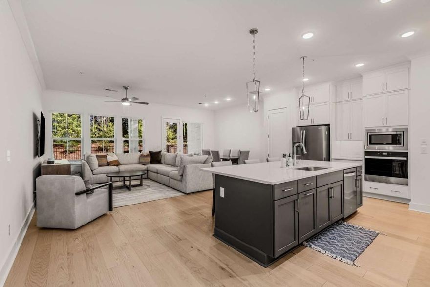 Live in a prime location close to everything. This beautiful 2 story Canterfield plan in an award-winning community by David Weekley lives like a single-family home. Harper Dr. is in the back of the community with no road noise. As you enter the front door into the foyer, you will see how wide the home is and how ample the space is for the living, dining, and kitchen spaces.  This home is meant for entertaining! Picture your family and friends interacting with you and each other in the fantastic living space.  The white kitchen cabinets are a great contrast to the darker wood island base and white quartz top.  The upgraded backsplash was added after purchase. You'll enjoy tons of cabinet and counter space, designer hood with a gas cooktop and stainless appliances. Through the back door, you will enjoy the spacious covered back patio overlooking a nice sized fenced backyard, rare in many townhome communities, and perfect for your four-legged friends! You can even enjoy hearing the church bells that ring every hour from the church across the street! As you climb the wide staircase, you will see the large landing, which is great for art display, an office, or a sitting area. To the right you will find two nice guest rooms and the guest bath with tile flooring and quartz countertops. Across the landing, you will enter your oasis.  This oversized primary bedroom has plenty of room for all your king-sized furniture and across from the bed area, put a comfy sitting area with the tv mounted there. The primary bathroom features updated tile floor, quartz countertops, a beautiful soaking tub and a large tiled shower.  What a great place for you to retreat!  Another nice addition is the screened porch off of the primary bedroom. Set up your wine fridge up there and relax after the end of the day! The laundry room is on the second floor. This community has a great pool area, great neighbors who all walk their dogs, and talk. The dog park is perfect for letting your pets release energy and best of all, this  location is only 2 miles from downtown Roswell and 2.5 miles from Downtown Alpharetta!  Get in now. You will love this way of living!