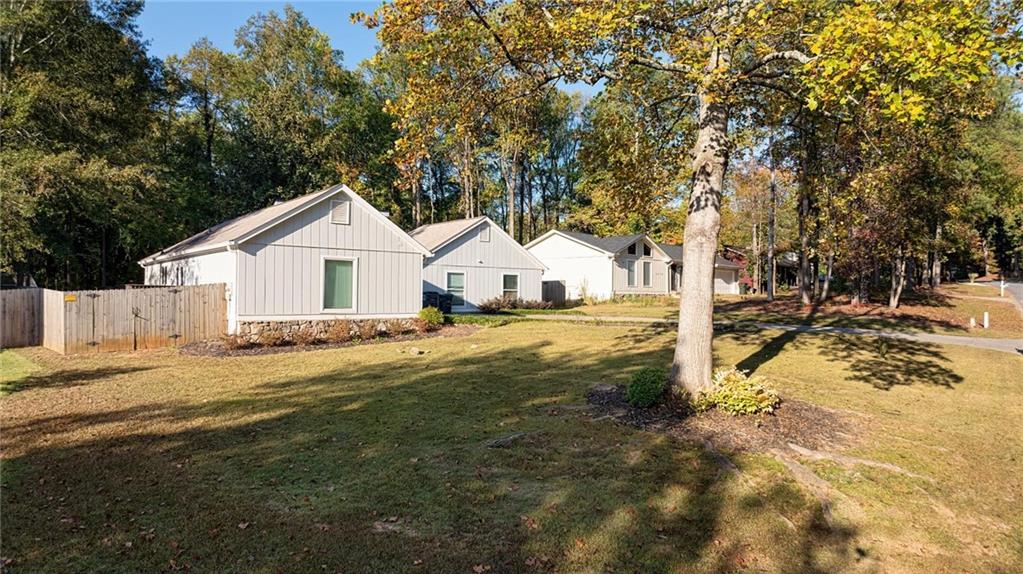 COMPLETELY renovated spacious RANCH home with a show-stopping kitchen featuring a huge statement island, quartz countertops, stainless appliances including GAS stove, farm house sink, recessed lighting and plenty of storage. The dramatic family room, entered through double doors, features a soaring vaulted ceiling with timbers, a full-height stone fireplace, tile floors and WET BAR with WINE fridge . This home features a large dining room and spacious bedrooms, fully renovated primary bath with stunning statement 'hers' vanity, jetted tub, and black hardware. Newly renovated family bathroom with butcher block counters. Upgraded fixtures and ceiling fans throughout, newer duct work and attic insulation, all windows are triple pane vinyl. Home is situated on a large lot with large fully fenced back yard, THREE storage sheds, concrete patio, and enormous deck. Incredible location, walking distance to grocery stores, Starbucks, movie theater and shops and restaurants! NO HOA so NO RENTAL RESTRICTIONS! Don't miss this one! Tenant occupied until 1/31/2025.