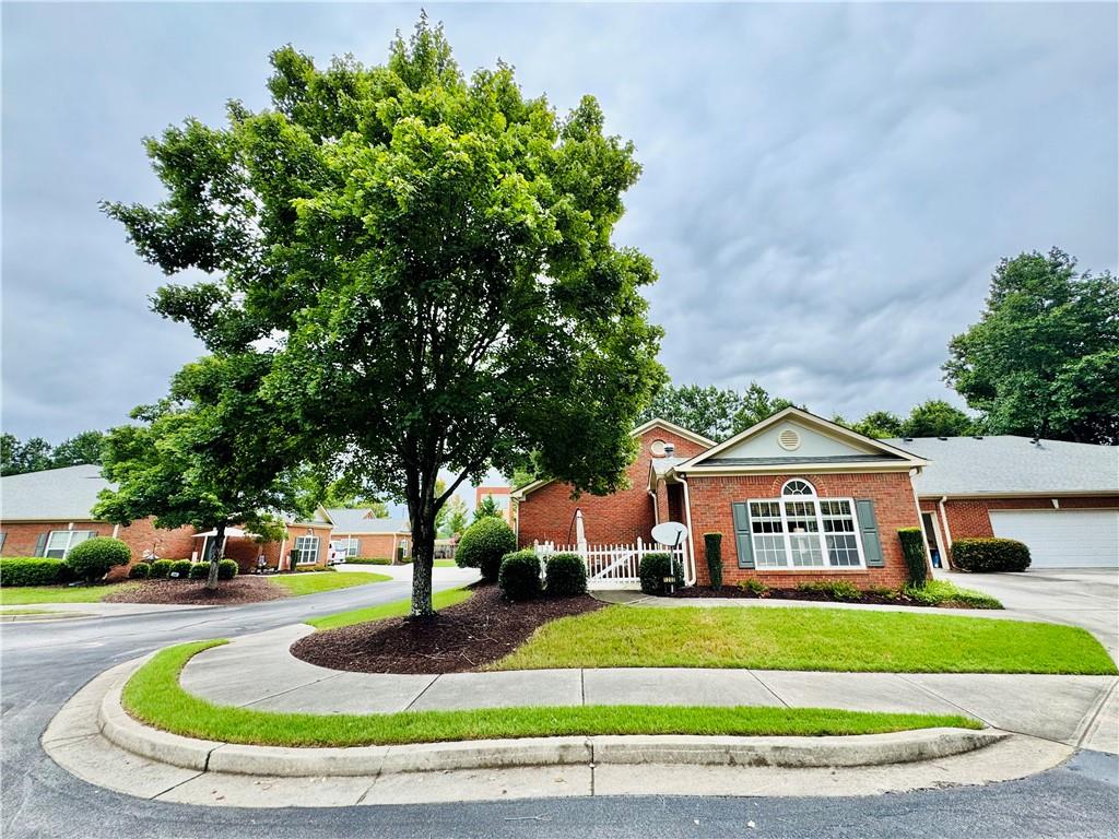 ***Presenting a rare chance to own a 2 bedroom / 2 bathroom ranch home in the most private / secluded spot in Buford's most sought after "Active 55+ Community", Friendship Corners! This beautifully constructed 4-sided brick ranch(condominium ownership)offers stepless, one-level living on a private cul-de-sac lot with side-driveway access to extended length, two-car garage parking. The garage features limo-depth parking, ample storage space on the sides and along the rear wall & a closet on the far right that houses the gas water heater, expansion tank, etc. The garage door is weather insulated and belt-driven, making it much quieter than chain driven garage doors. The overhead garage door opener is 3 years old & includes a remote for programming "HomeLink" garage door opening software found in most vehicles.
This home is extraordinarily well kept and features a lovely open floor plan offering a large family room, complete with vaulted ceilings. At the center of it all is a very pretty, glass front, gas fireplace that is operated by a light switch on the wall next to it. A beautifully designed and built wood mantel surrounds the fireplace, making for a picturesque holiday photo setting. A very low use and very pretty "eggshell" colored carpet covers the floor in the living room, the dining room, both bedrooms & both closets & the hallway leading to the two bedrooms. The kitchen features a generous amount of counter space, quality wood-stained cabinetry that provides more than ample storage, a large, two-sided stainless steel sink with new hose & faucet sprayer combo unit & an eat-in breakfast bar just above that. The floor immediately inside of the front door features a 5 foot x 5 foot area of hardwood flooring.
The primary suite has very large double walk-in closets, ample square footage, a ceiling fan, and 10 foot ceilings, etc. The primary bathroom features an over-sized walk-in shower and a double vanity / double sink configuration with increased height cabinets & countertops. The secondary bedroom enjoys plenty of natural light through double-paned, double windows. The second bedroom also features a ceiling fan / light that is activated by a wall switch. The secondary bathroom is ideal and offers a double vanity sink-countertop space, along with a very nice shower/tub combo in white with a shower curtain. Both bathrooms have extended mirror coverage above the sinks, proper lighting & exhaust fan in the ceiling.
The outdoor living space gets an A + as it is the perfect patio space to relax in, entertain friends, neighbors and guests. This patio space is available for furniture, rocking chairs, umbrellas, tables, raised gardens, potted plants, flowers, bushes, etc. The relaxing private patio area alone looks out onto a gardened and purposefully landscaped wooded forest that is lush & beautiful. These wooded areas that the home looks out onto are as peaceful as they are private! The monthly HOA fees cover water, dwelling maintenance, termite bond, landscaping / lawn service, reserve fund, trash, sewer, pool access to the community swimming pool. Come and see why so many people have shared in the same positive and immediate reaction upon learning of this community and its stunning building designs, location and value. It is also within close proximity of the City of Braselton, Mall of Georgia, Sugarloaf Mills, Historic Buford, Treetop Quest Gwinnett, Lake Lanier, North Georgia Premium Outlets, highly rated dining & shopping. World class hospitals, trauma centers, ER's are all nearby as are the main expressways needed. ***The side-by-side washer and dryer units will convey with the property at closing.***