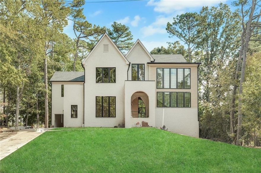 Come see this inviting new construction home nestled in a prime Sandy Springs location, offering the perfect blend of elegance, comfort, and modern living. Step through the portico arch entry into a grand foyer with soaring 10-foot ceilings and stunning hardwood floors that flow throughout the home. The main level features a guest suite with a full bath, a separate dining room with vaulted ceilings—ideal for entertaining. The heart of the home is the designer kitchen, complete with top-of-the-line appliances, custom cabinetry, and a spacious scullery, all overlooking the family room and a cozy fireplace. A mudroom off the kitchen adds convenience, while thoughtful design elements create a seamless flow for everyday living. Upstairs boasts vaulted bedrooms, and a luxurious primary suite with a spa-like bath featuring custom walnut double vanities, a soaking tub, separate shower, and large walk-in closet. The upper level also includes three additional ensuite bedrooms and a convenient laundry room, providing space and functionality for family and guests. Enjoy outdoor living at its finest with a covered porch featuring a fireplace overlooking a private backyard with plenty of room for a POOL. This 5-bedroom, 5.5-bath home also includes a 3-car garage and an UNFINISHED basement—offering endless potential for customization to suit your lifestyle. Perfectly situated in the heart of Sandy Springs, this home combines the tranquility of a private setting with the excitement of nearby premier shopping, dining, and entertainment. Every detail has been thoughtfully designed to offer both comfort and sophistication in one exceptional home.