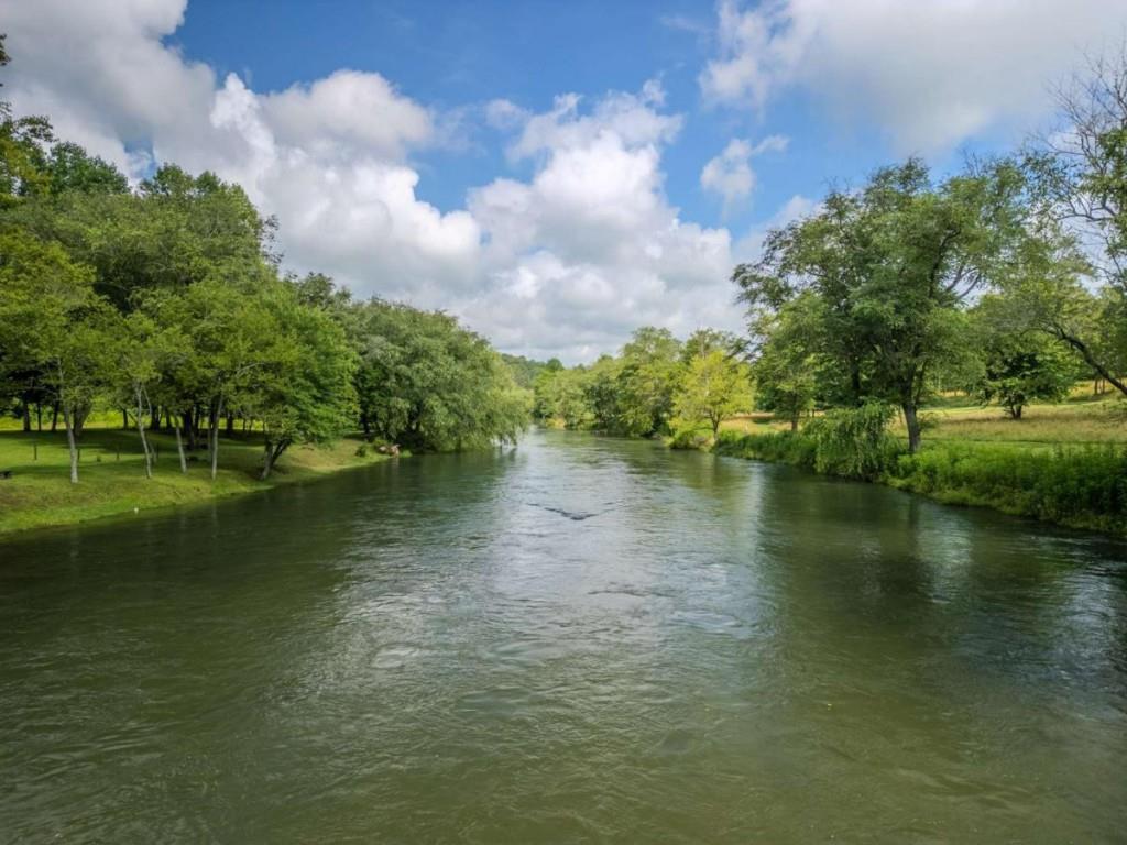 Riverfront Dreamin' on the Toccoa! Welcome to your slice of paradise-1.28 acres of pristine Toccoa River frontage with over 100 feet of rushing water right at your feet! Nestled in a gated community with a beautiful community pavilion right on the river, it's the perfect place to relax, entertain, and soak in those mountain vibes. Located across from Old Toccoa Farm Golf Course and just downstream from the historic Native American fish traps, this coveted stretch is known for some of the best fishing on the river. You'll enjoy underground power, city water, and be just minutes (under 5 miles!) from downtown Blue Ridge-giving you the best of both nature and convenience. Whether you're dreaming of a cozy cabin or your forever getaway, this is your chance to build the ultimate riverfront escape. Don't just visit the Toccoa-live it!