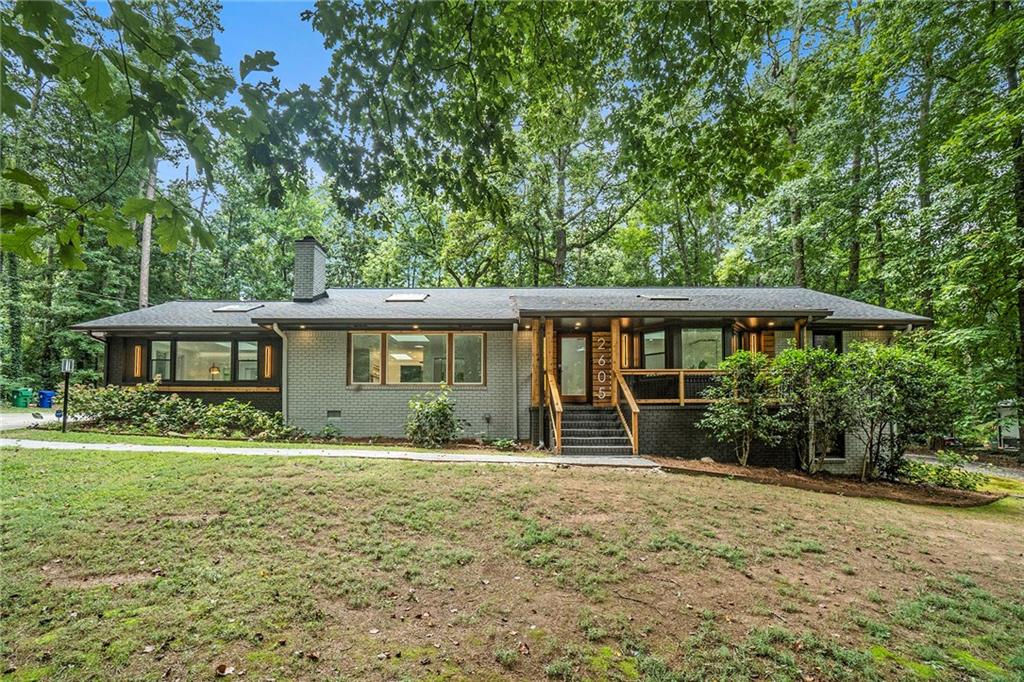 Set on a secluded 1.24-acre property, this masterfully re-imagined mid-century brick and cedar ranch is a rare opportunity to own a home on one of Decatur's most prized streets. The yard is framed by a canopy of mature hardwoods and lush landscaping, offering both privacy and an intimate connection to nature. A comprehensive renovation was completed in 2025, blending architectural integrity with thoughtful refinement. Inside, natural light is abundant thanks to strategically placed skylights and sun tunnels. Expansive picture windows and French doors invite the outdoors in, creating a serene, gallery-like atmosphere. A redesigned kitchen and laundry space along with smart home automation, commercial-grade Wi-Fi infrastructure, LED lighting, sophisticated fixtures, newly refinished hardwood floors, a new architectural shingled 2025 roof, and all new casement windows are just a few of the reasons you'll love this home. Almost no stone has been left unturned. Although listed as a 3 bedroom, the office can be easily re-converted to a 4th bedroom if desired. The unfinished downstairs area is perfect for additional storage, a game room/gym, or it can be finished out for more living space (has been pre-plumbed). The home is only 2 miles from Decatur square, where you can take a stroll to the many wonderful shops, restaurants, festivals, and live music. The 77-acre Legacy Park, connected to the Greenway, is less than a mile away w/ wetlands, athletic fields, & community gardens. The Museum Charter School is also very close. No city taxes. This is the one you've been waiting for!
