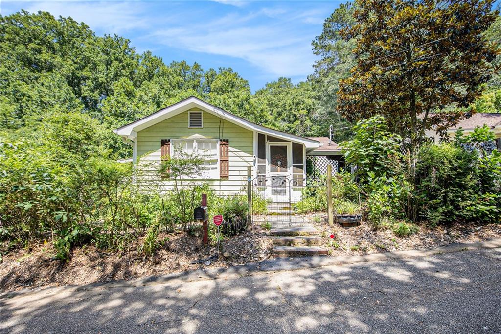 Charming 3 Bedroom, 2 Bath Cottage in Historic Lake Acworth District!
Welcome to this unique opportunity in the Historic Lake Acworth District! This 3-bedroom, 2-bath cottage is full of character and offers endless potential for the right buyer. The home features a spacious master suite with a private shower, secondary bedrooms with ceiling fans, and a cozy kitchen ready for your personal touch. The large living room provides a great space for entertaining, while two covered, screened-in porches offer the perfect spots to relax and enjoy the outdoors.
With a unique roommate-style layout, two of the bedrooms have their own private entrances and exits—ideal for added privacy or flexible use. Situated on a level lot at the end of the street, the property also includes a 1-car carport and an outbuilding for extra storage. Nestled in a peaceful location and just minutes from Lake Acworth, this home is perfect for a first-time homebuyer, investor, or anyone looking to add their own personal touches and create a dream space.
