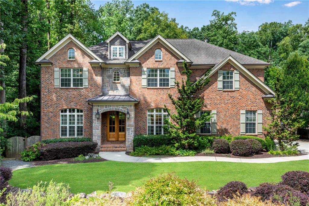 Custom built, four-side brick home with expansive entertaining space and amazing, park-like backyard on quiet circle in desirable Dunwoody neighborhood. Six bedrooms with five full bathrooms. Chef's kitchen with stainless steel Thermador appliances and large island that looks out to private, serene outdoors. Main level with spacious great room that features 12-foot coffered ceiling, large dining room, guest suite as well as separate office. Generous primary suite with vaulted ceiling and sitting room, large upscale bath with oversized shower and inviting soaking tub. Enormous custom closet. Three additional bedrooms with two baths (including Jack and Jill). Second level with step-up bonus/craft/media room. Terrace level boasts of large second living area, fabulous media room, bedroom suite w/full bathroom, as well as second laundry room and workshop. Expansive Trex deck provides wonderful views of private backyard with wall-mounted TV. Separate rear screened porch with wood-burning fireplace is perfect for morning coffee or relaxing after-hours beverage. Under-deck, outdoor living space. Professionally landscaped, fully-fenced backyard features graveled area perfect for a firepit, wonderful herb garden and room for a swimming pool. Three-car garage. A short stroll to the restaurants and shops of Dunwoody Village, as well as nearby Brook Run Park, Marcus Community Center, Dunwoody Nature Center and Perimeter Mall. Join any of Dunwoody's popular swim/tennis clubs. Low voltage, structured wiring and ethernet throughout. A meticulously maintained one-owner home.