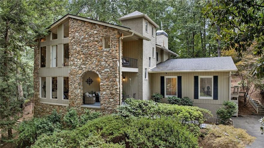 Nestled on a private 1-acre lot across from Dunwoody Country Club Golf Course, this timeless modern residence offers the perfect balance of serenity, privacy, and refined design. Ideally situated just minutes from shopping, dining, and GA-400, the home showcases exceptional craftsmanship with vaulted ceilings, floor-to-ceiling windows, and a beautiful year-round sunroom with casement windows. The main level welcomes you with a gracious foyer, formal dining room, private office or sitting room, and expansive family and living rooms, all with breathtaking views of nature and the golf course. A private guest suite with full bath provides comfort and convenience. The chef’s kitchen combines function and style, featuring stone countertops, white cabinetry, breakfast bar, and a sunlit eat-in area overlooking the tranquil koi pond and waterfall. Outdoor living shines with an expansive deck, ideal for entertaining, al fresco dining, or quiet relaxation. Upstairs, the owner’s suite is a true retreat with vaulted ceilings, a private covered porch, large walk-in closet, and spa-inspired bath with tongue-and-groove ceiling, skylights, whirlpool tub, and double vanity. Two additional bedrooms, a full bath, and a versatile office or exercise room complete the upper level. The lower level offers a side-entry garage, workshop, and ample storage. Surrounded by lush landscaping, mature trees, and the calming backdrop of the golf course, this property delivers a rare blend of natural beauty, privacy, and convenience, just minutes from top-rated schools, parks, and all that Dunwoody has to offer.